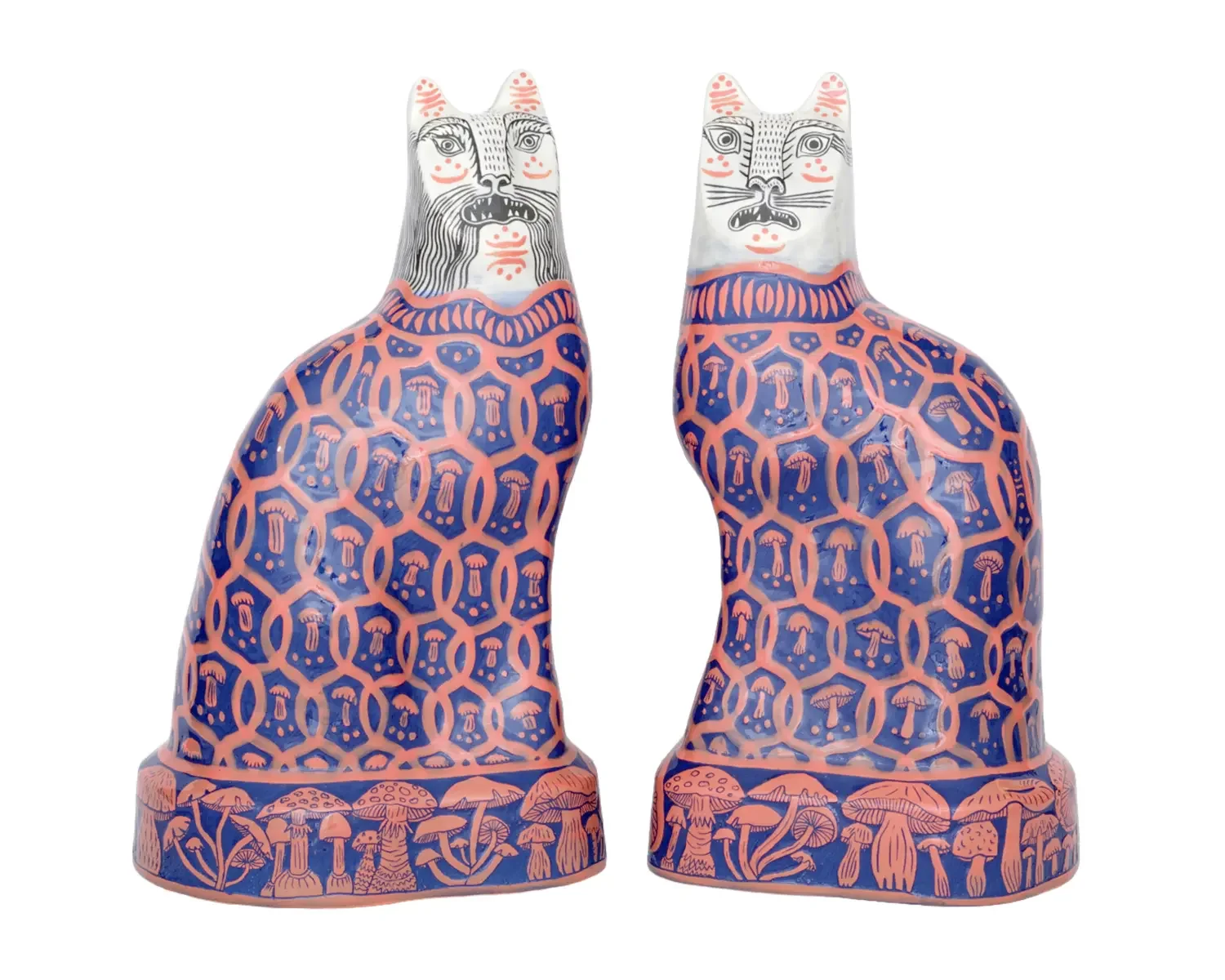 Decorative ceramic sculptures of cats with intricate patterns, featuring mushroom motifs, set against a white background.