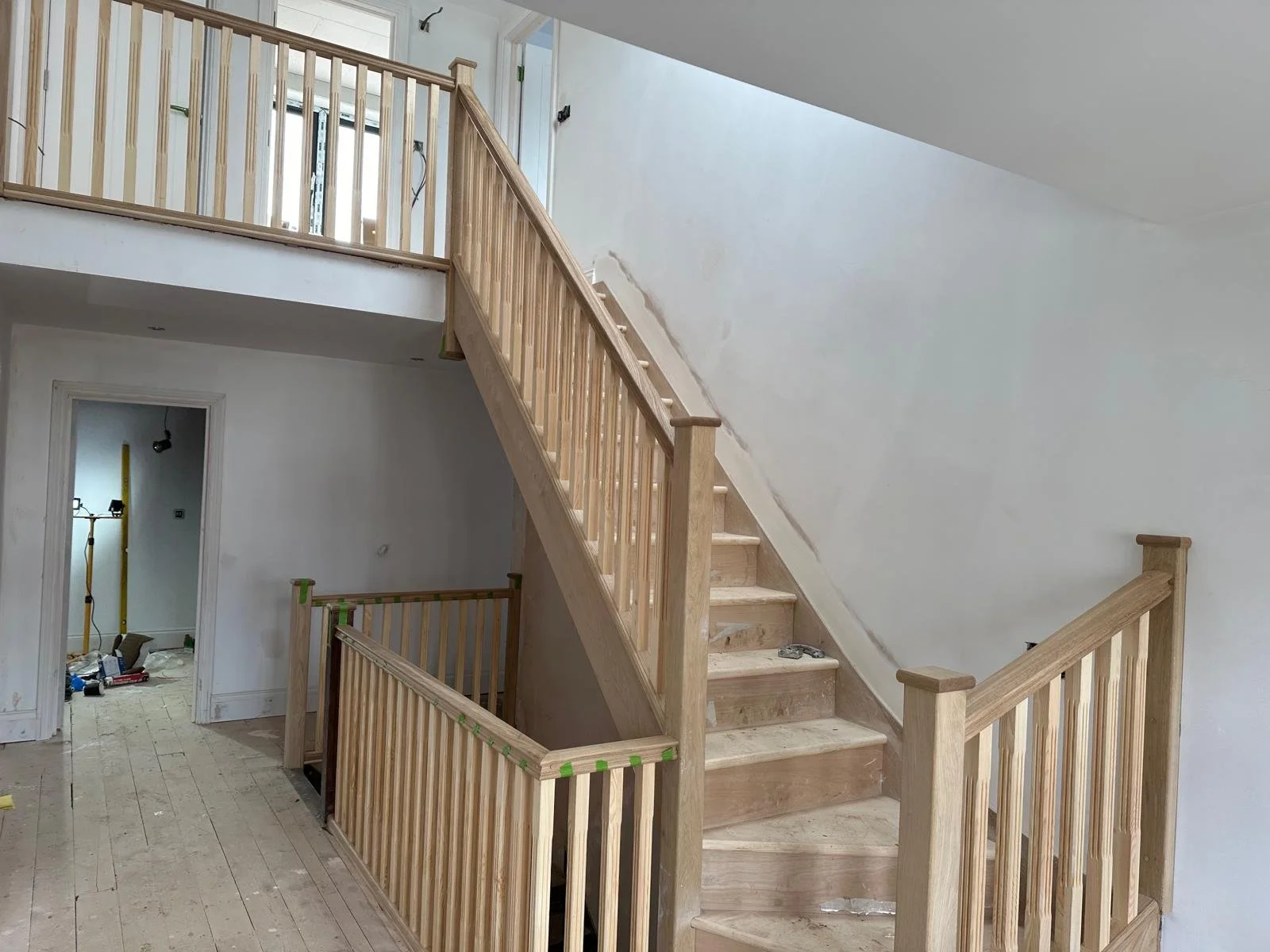 Interior view of a house under construction, hand made stairs. Carpentry and Renovation by DA Build in London, Surrey and Greater London.