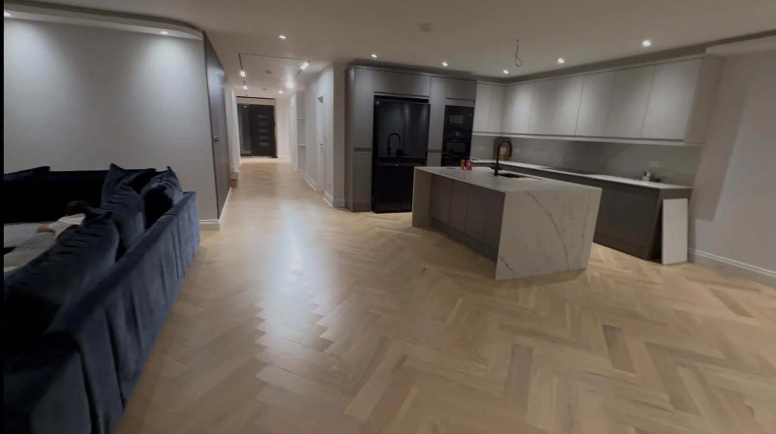 Spacious modern open-plan living area with a kitchen from home renovation.  Carpentry, construction and Renovation by DA Build in London, Surrey and Greater London.