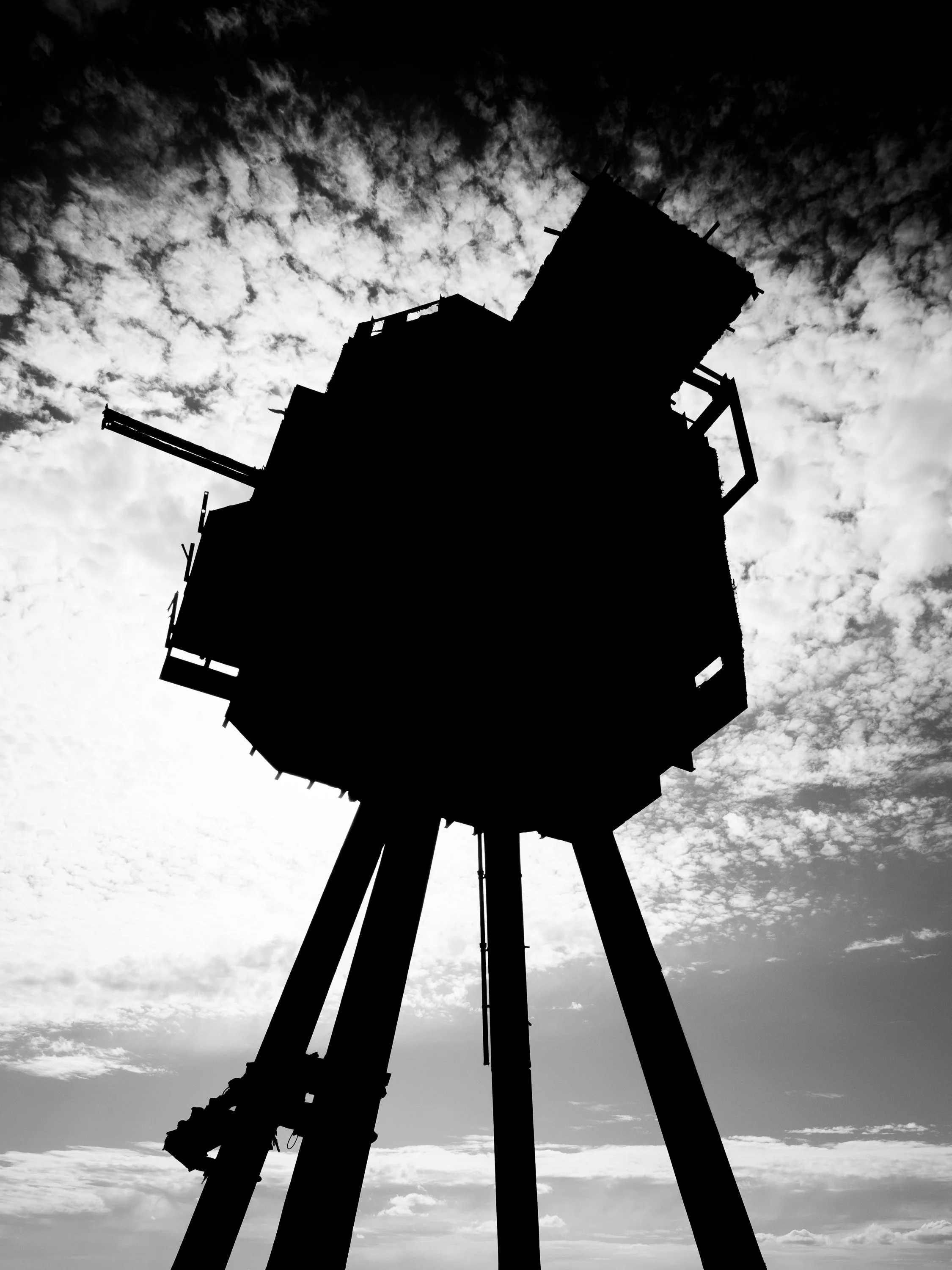 Maunsell Sea Fort silhouetted against a bright, clouded sky in the Thames Estuary.