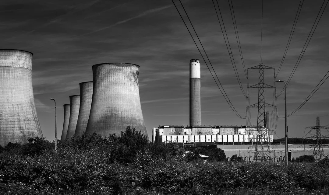 Ratcliffe-on-Soar Power Station's cooling towers, chimney and electricity pylons forming a layered industrial landscape.