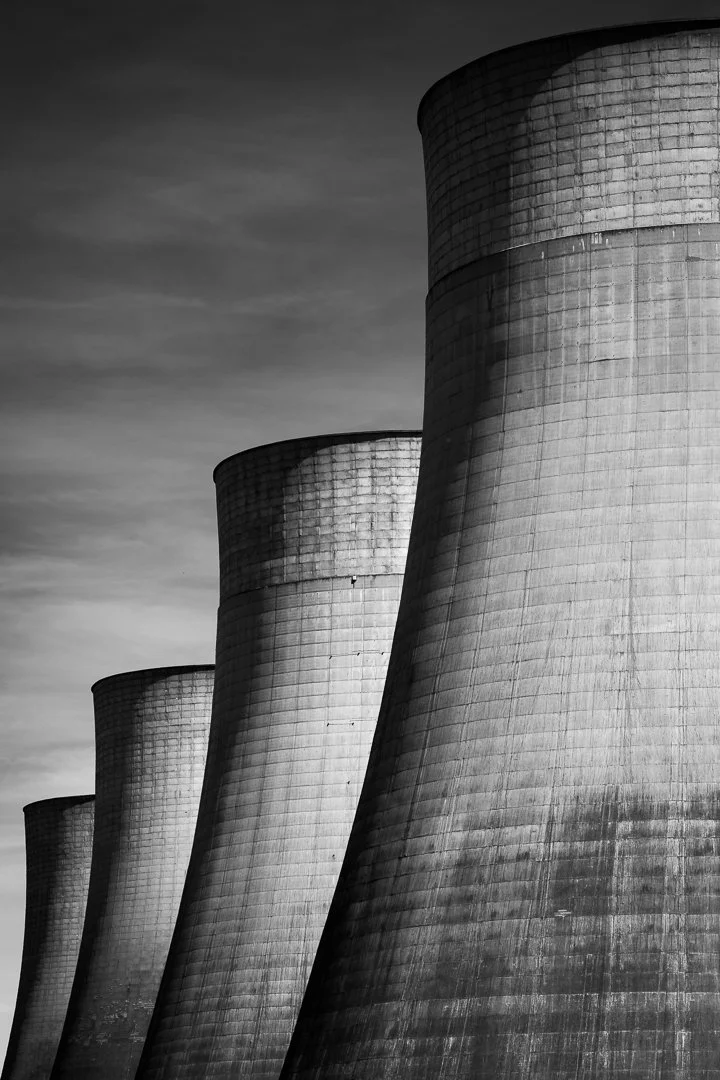 Close-up architectural study of Ratcliffe-on-Soar's concrete cooling towers, emphasising their curved forms, scale and textured surfaces.
