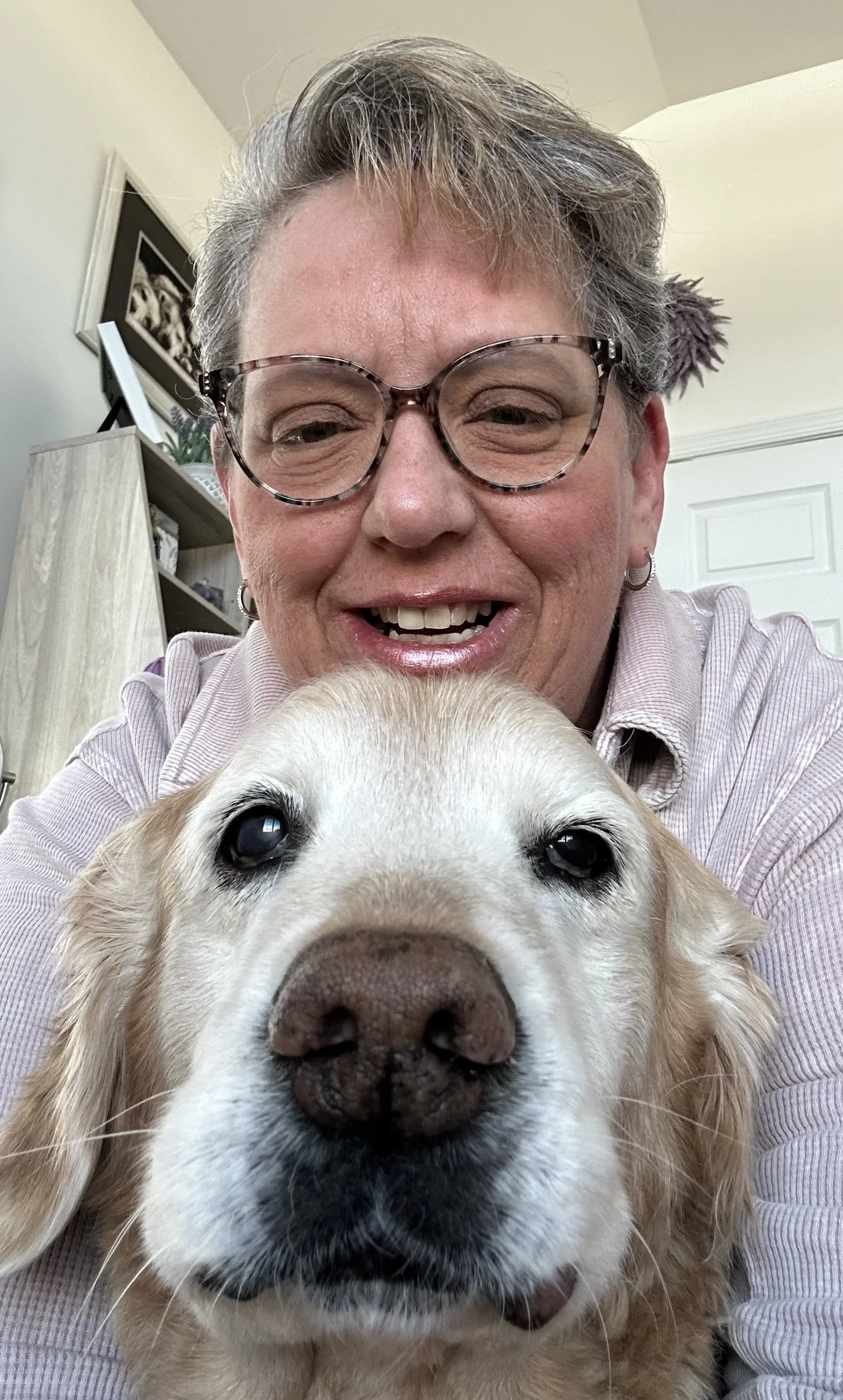 Woman hugging her golden retriever