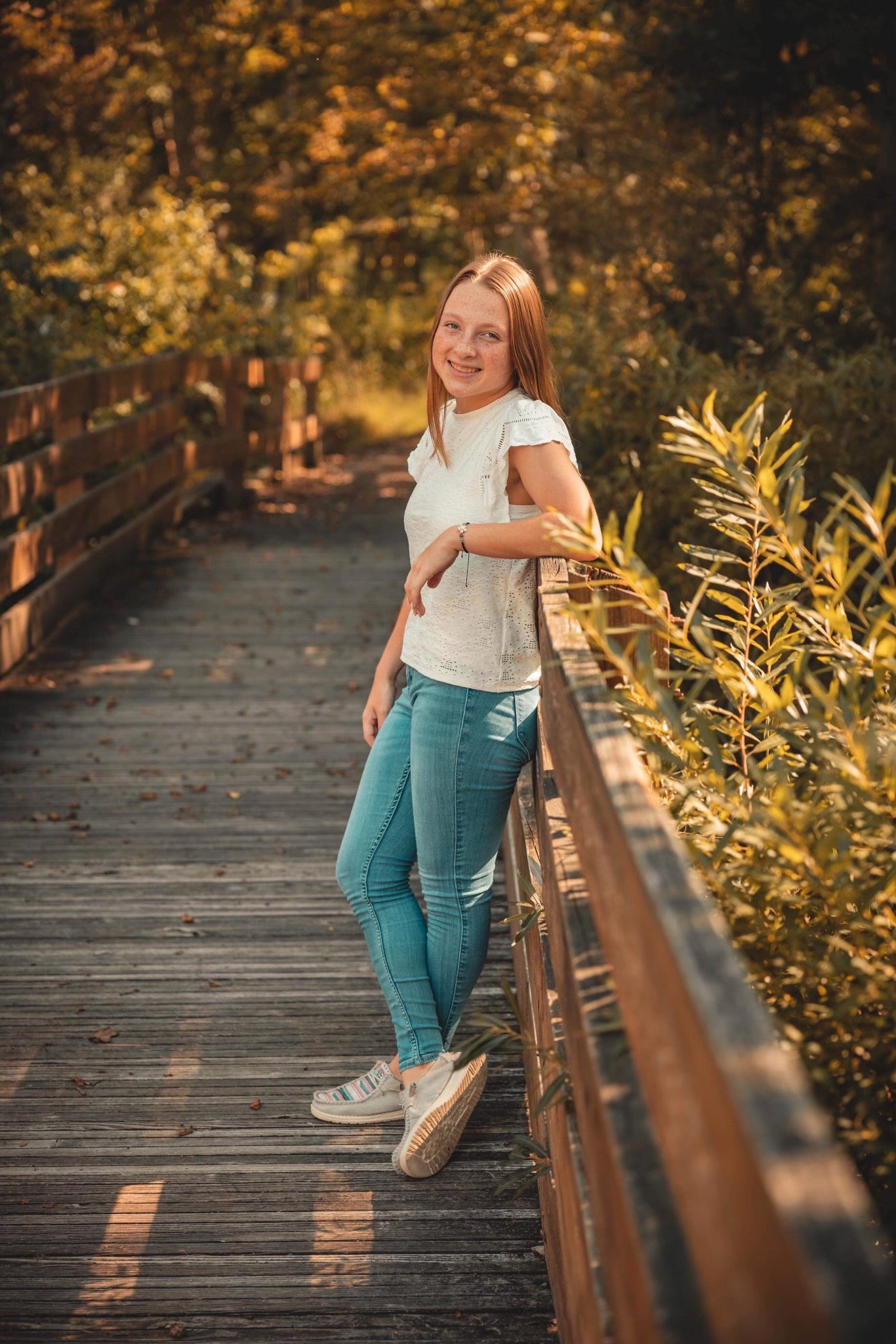 Young woman leaning on bridge railing