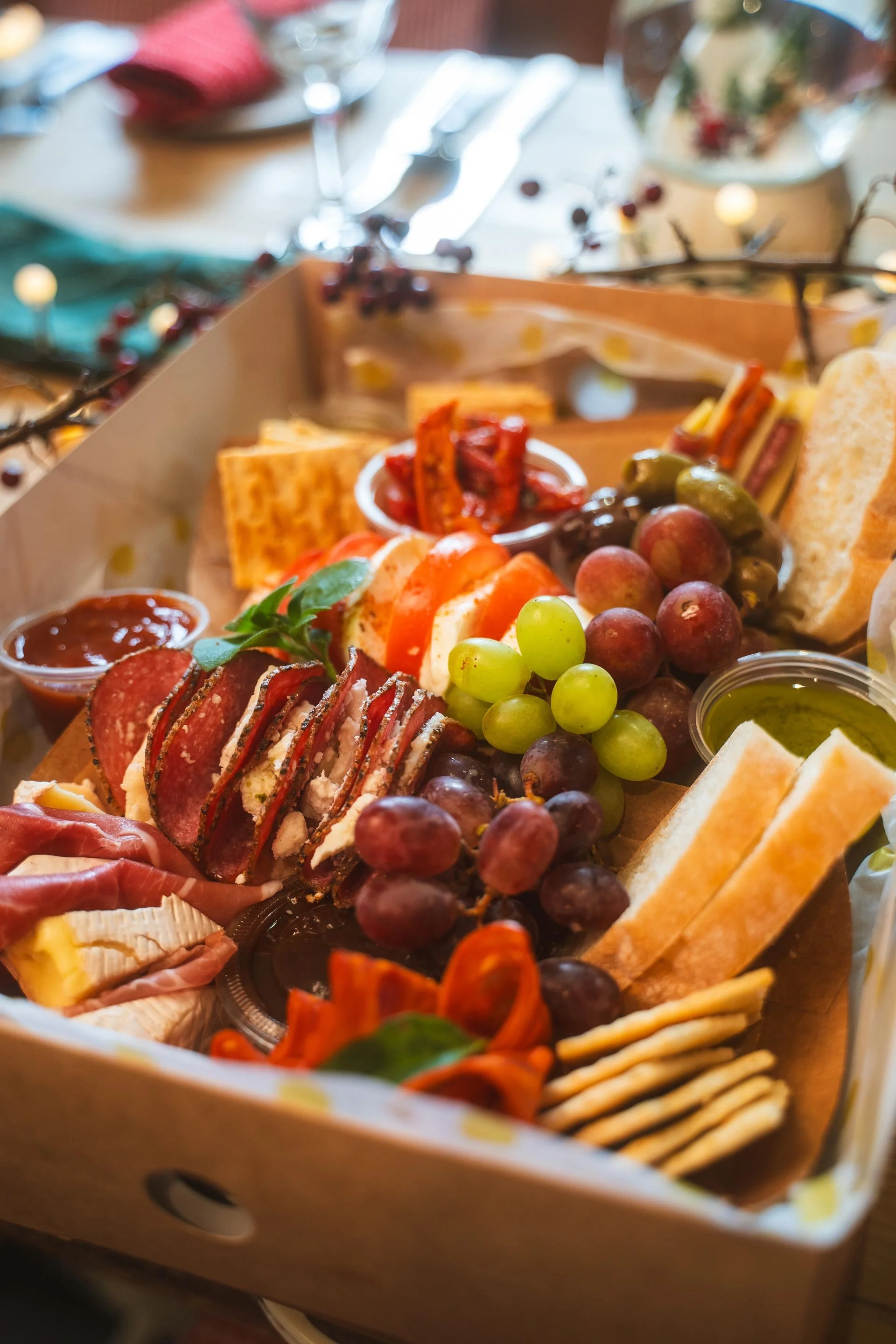 Charcuterie hamper box filled with cured meats, Irish cheeses, grapes, crackers and fresh fruit