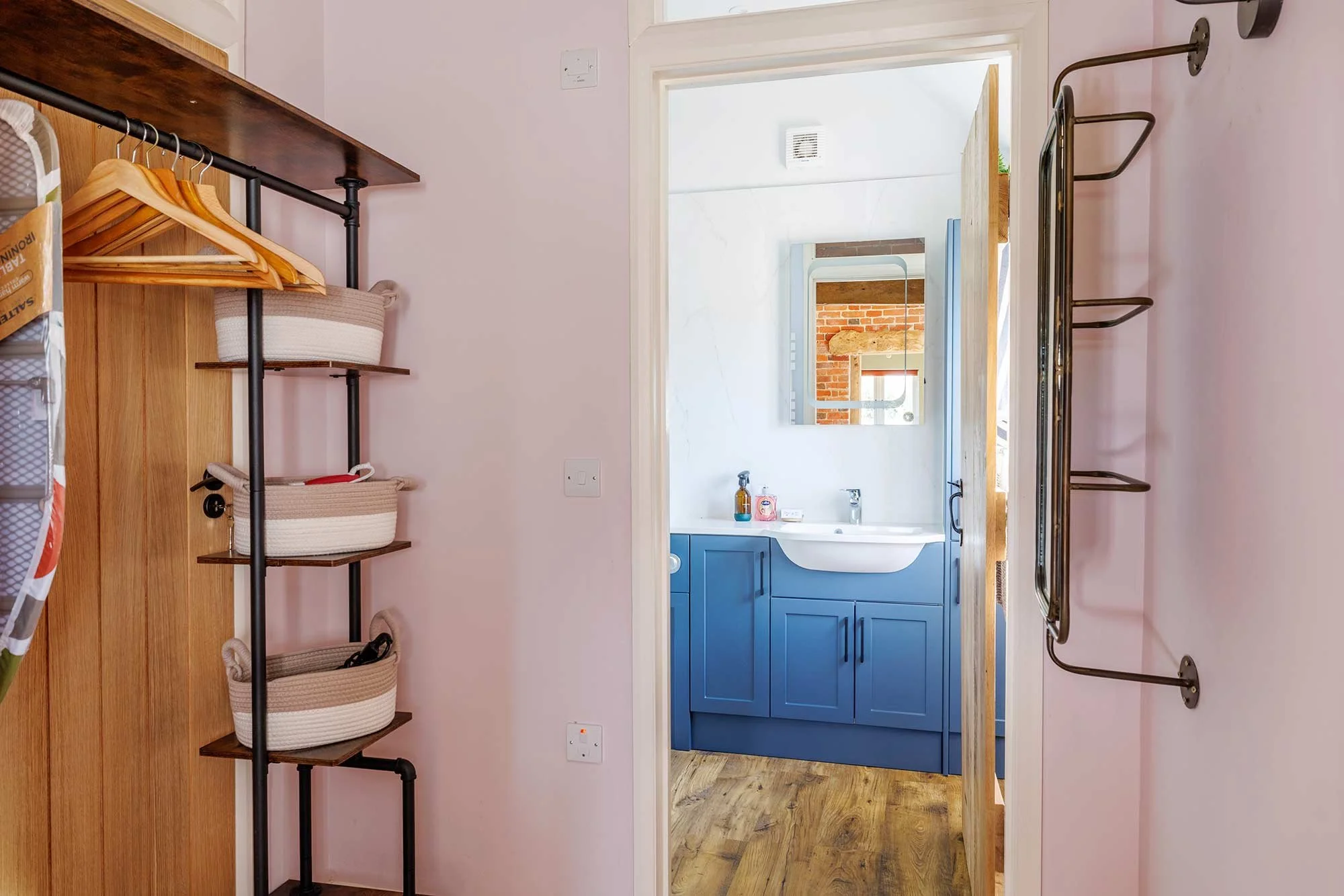 View through a bathroom with a blue vanity unit