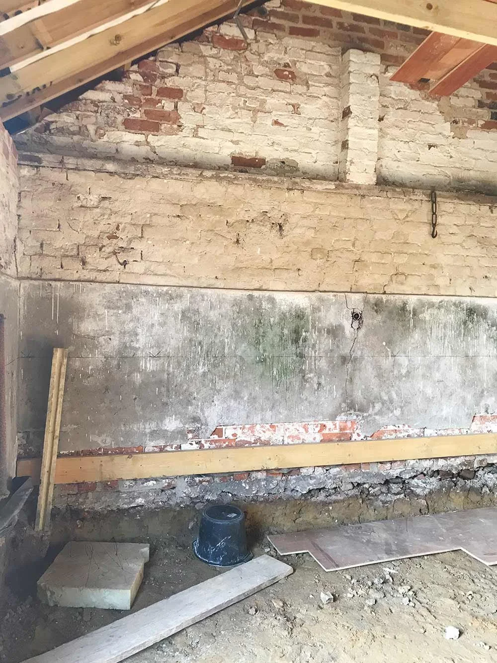 Barn interior during renovation with exposed brick.