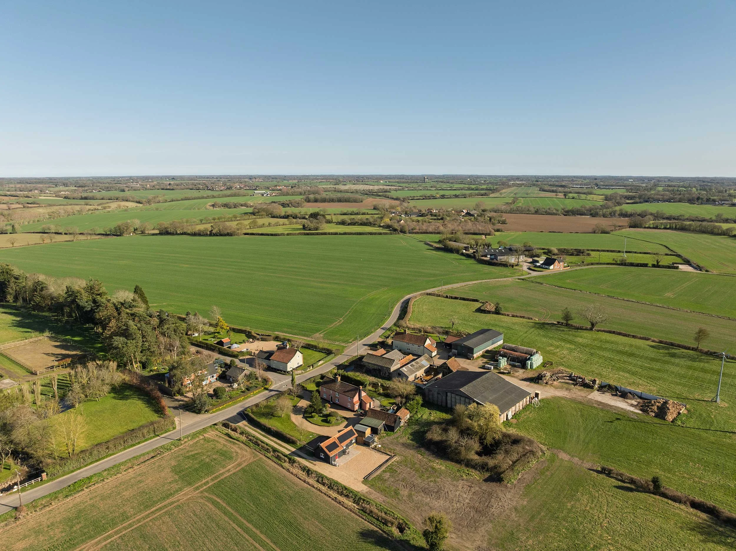 Aerial view of Albert's Dairy and Earsham Street surrounded by green fields.