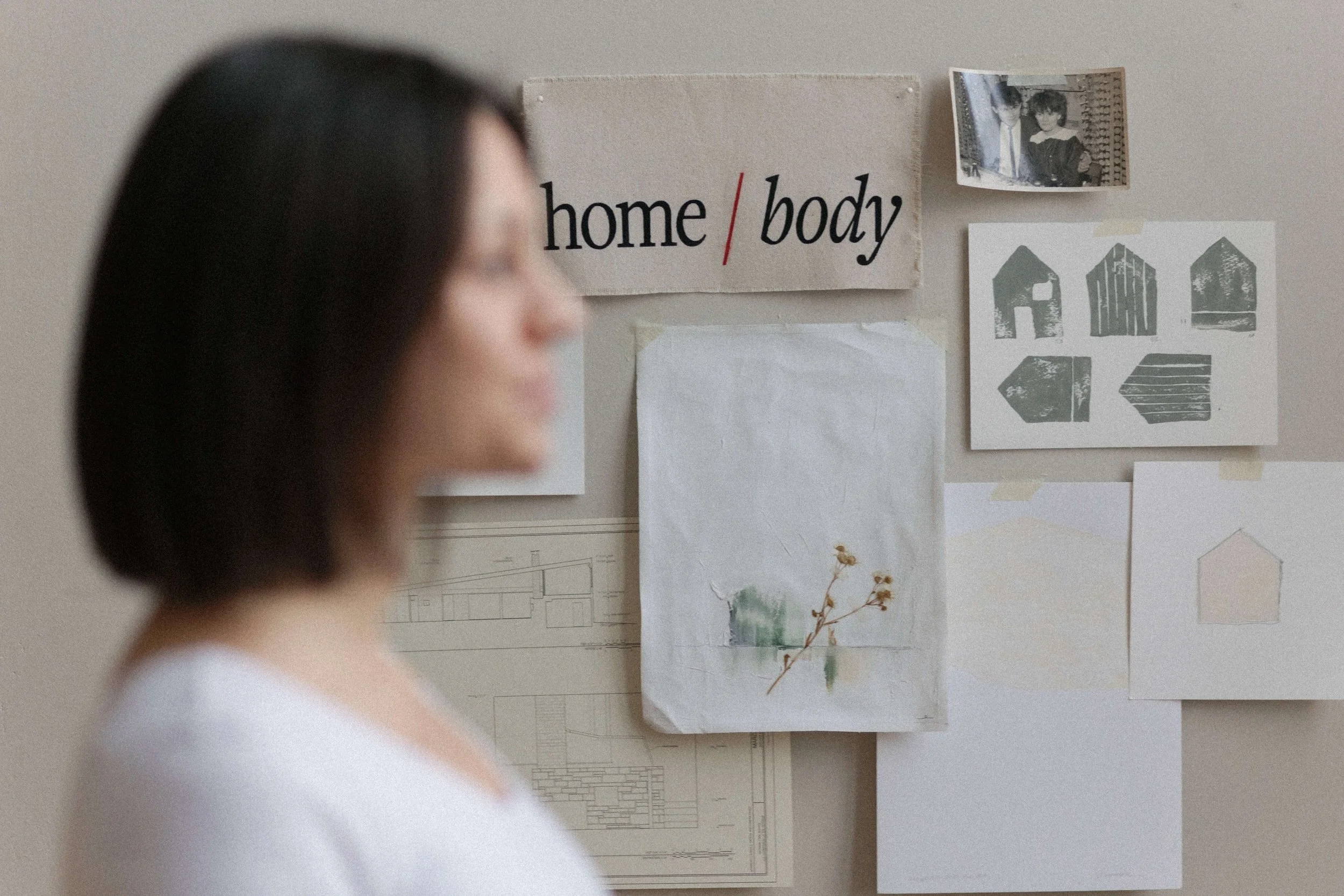 Home moodboard on wall with Ewelina standing in front - personal branding studio - studio domka