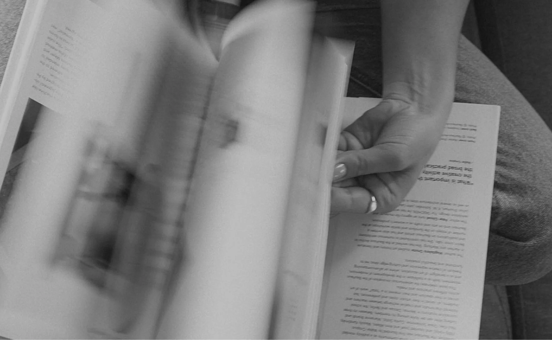 Close up shot of flipping through magazine pages on low exposure