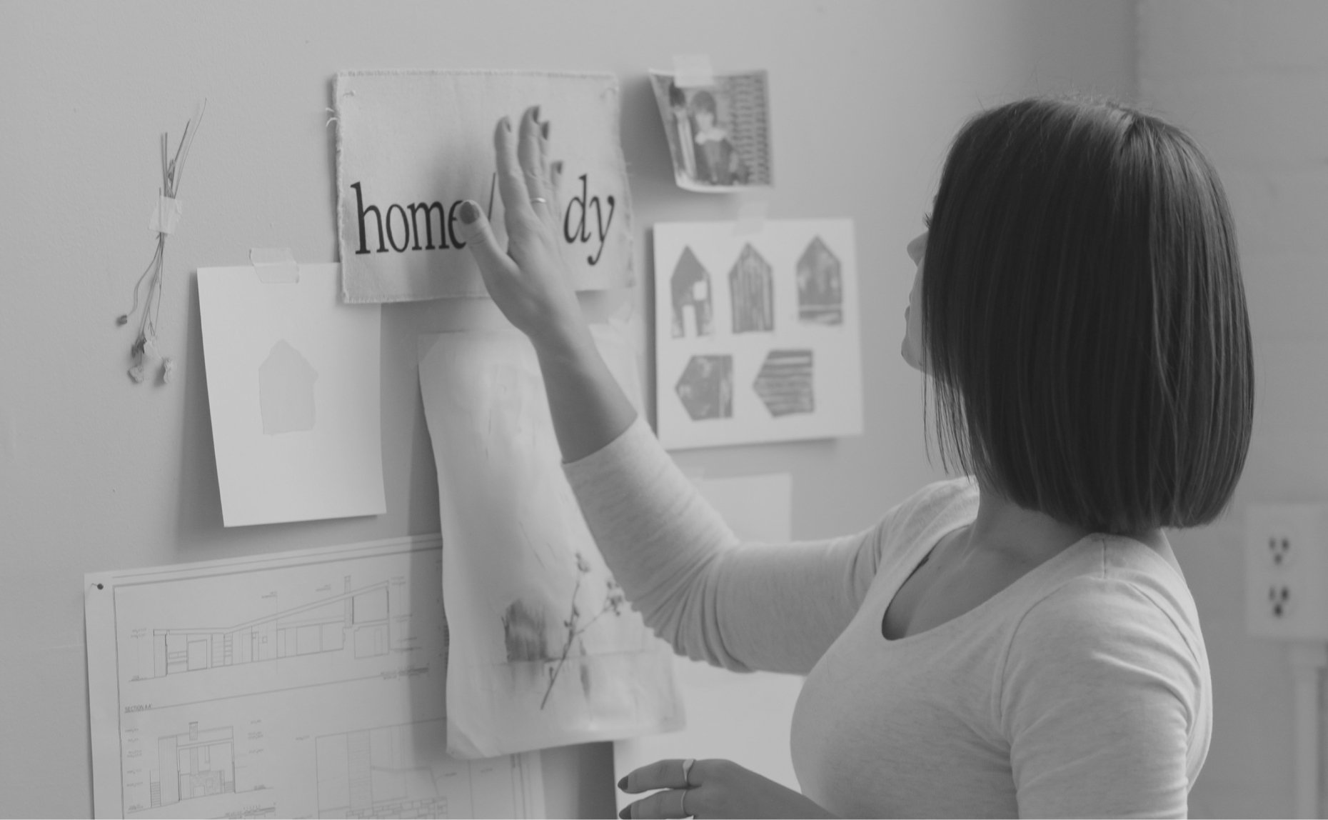 Ewelina pinning images to a creative moodboard on the wall of the studio - personal branding studio - studio domka