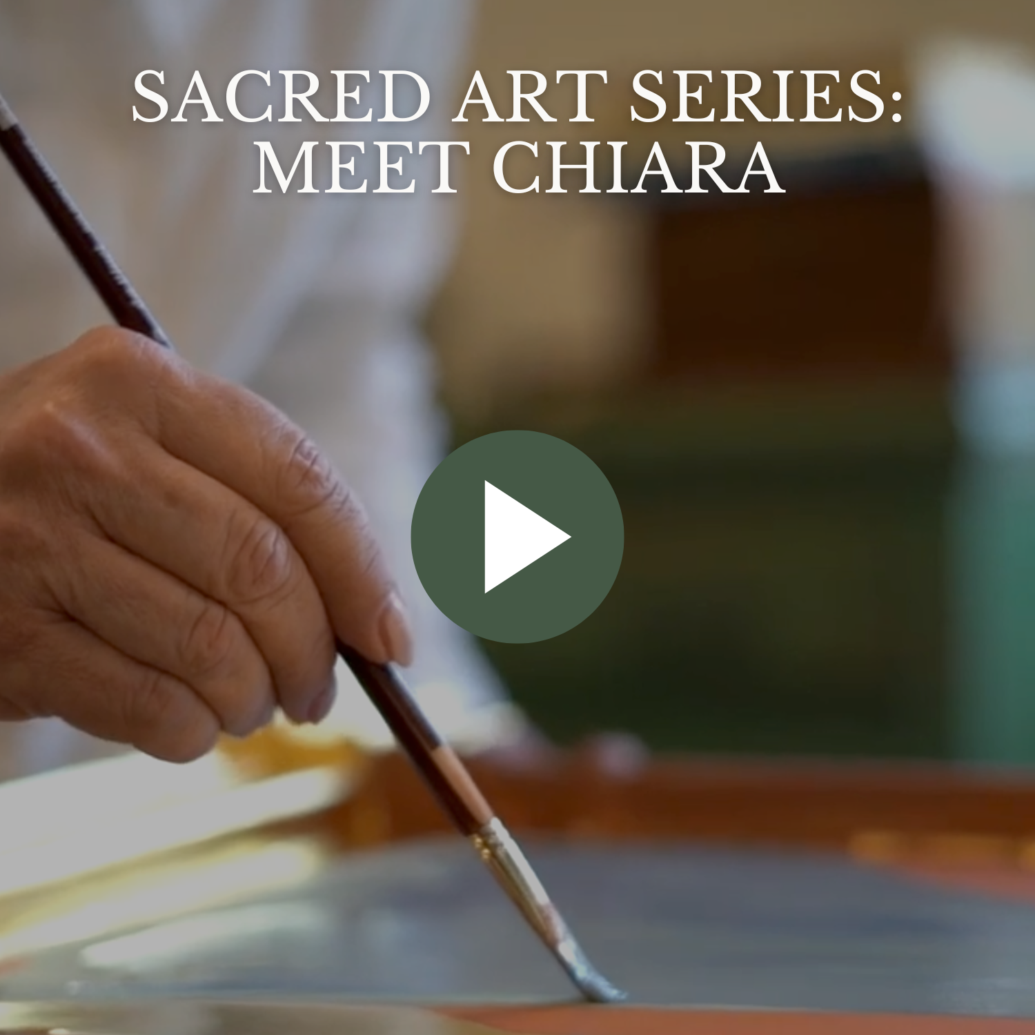 Close-up of a person’s hand holding a paintbrush, painting a piece of artwork. Text overlay reads 'Sacred Art Series: Meet Chiara' with a play button in the center.
