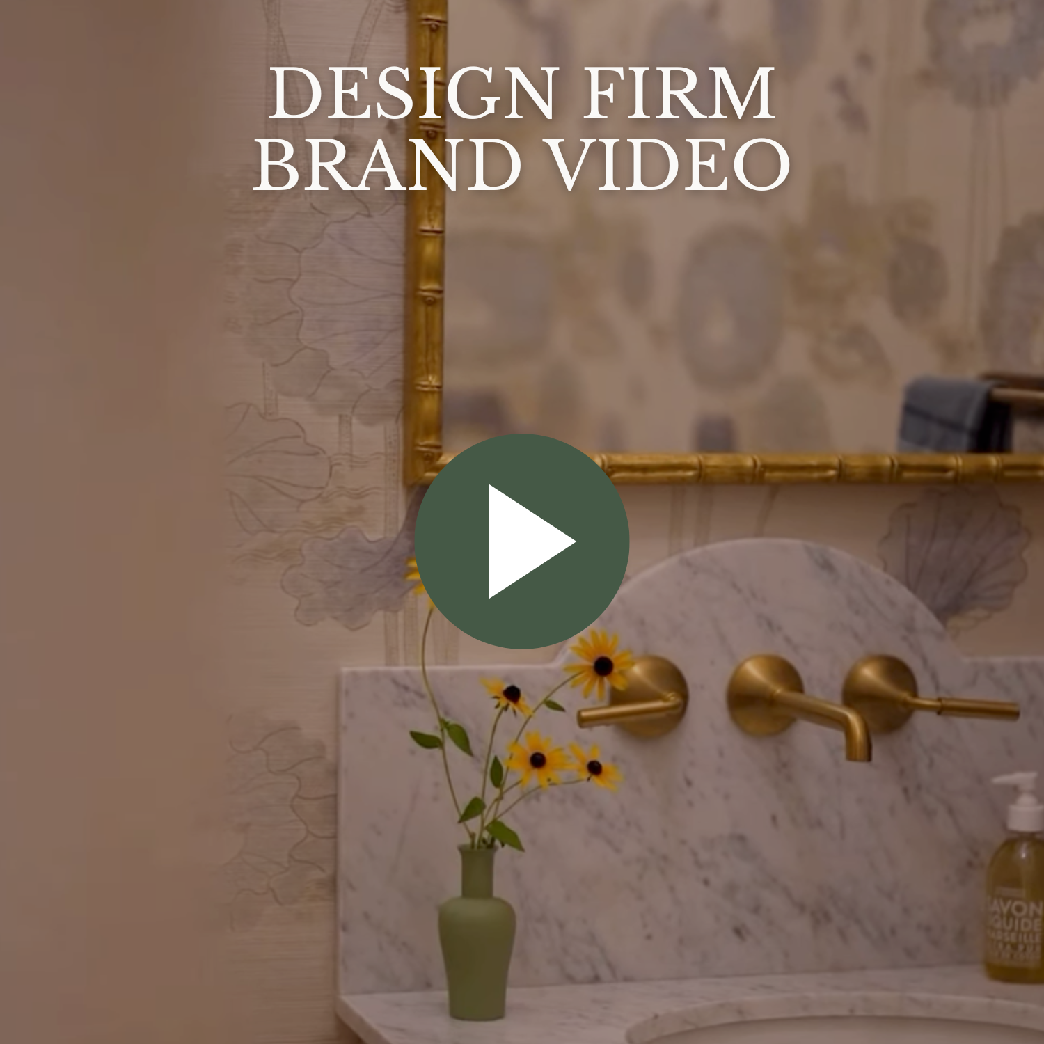 Video thumbnail showing a bathroom with a gold framed mirror, a marble countertop, a small green vase with yellow flowers, and a soap dispenser.