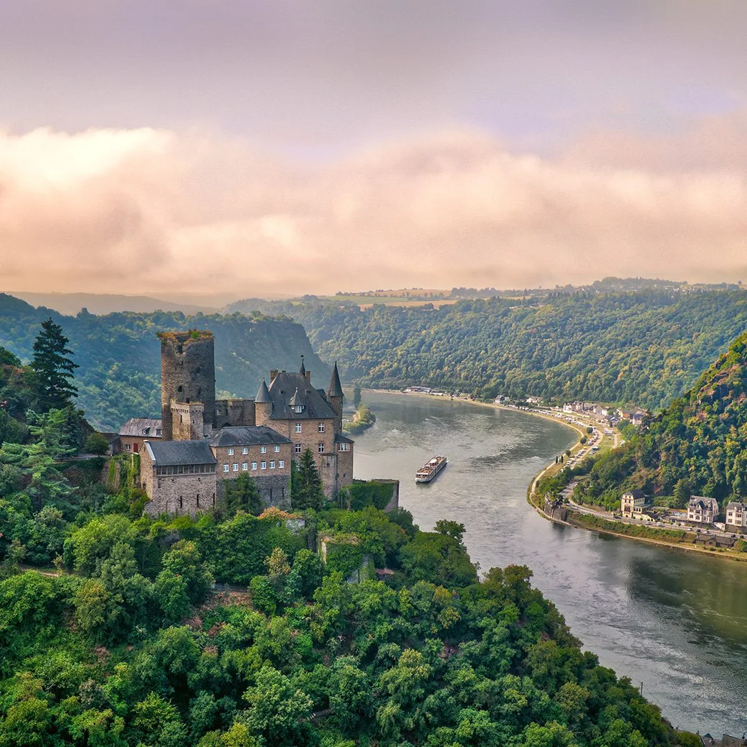 A castle above a winding European river