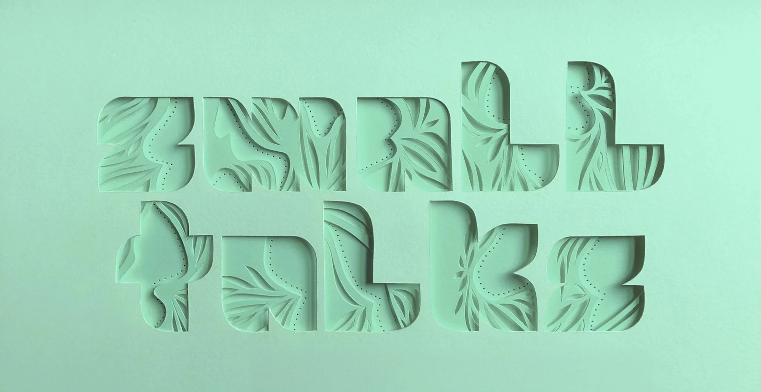 Cut-out paper art spelling 'SMALL BIZ' with tropical leaf patterns in mint green.