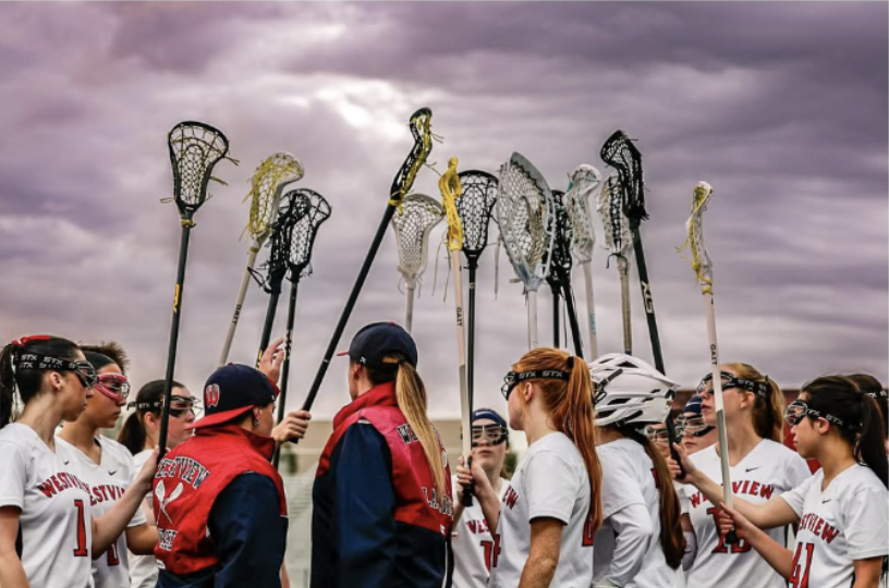 Westview Women's Lacrosse team and coaches in a huddle