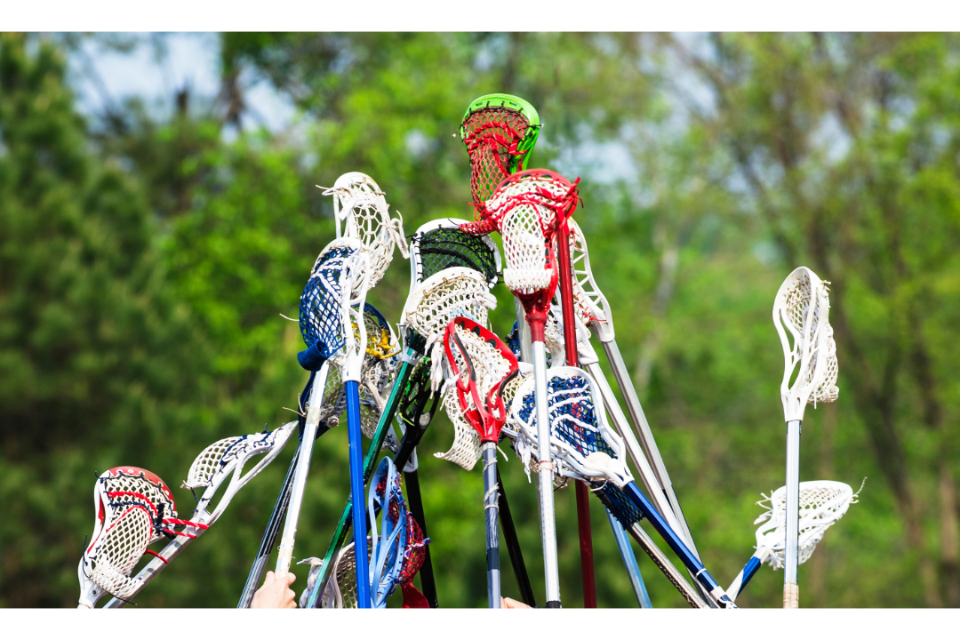 Lacrosse sticks being held up together.