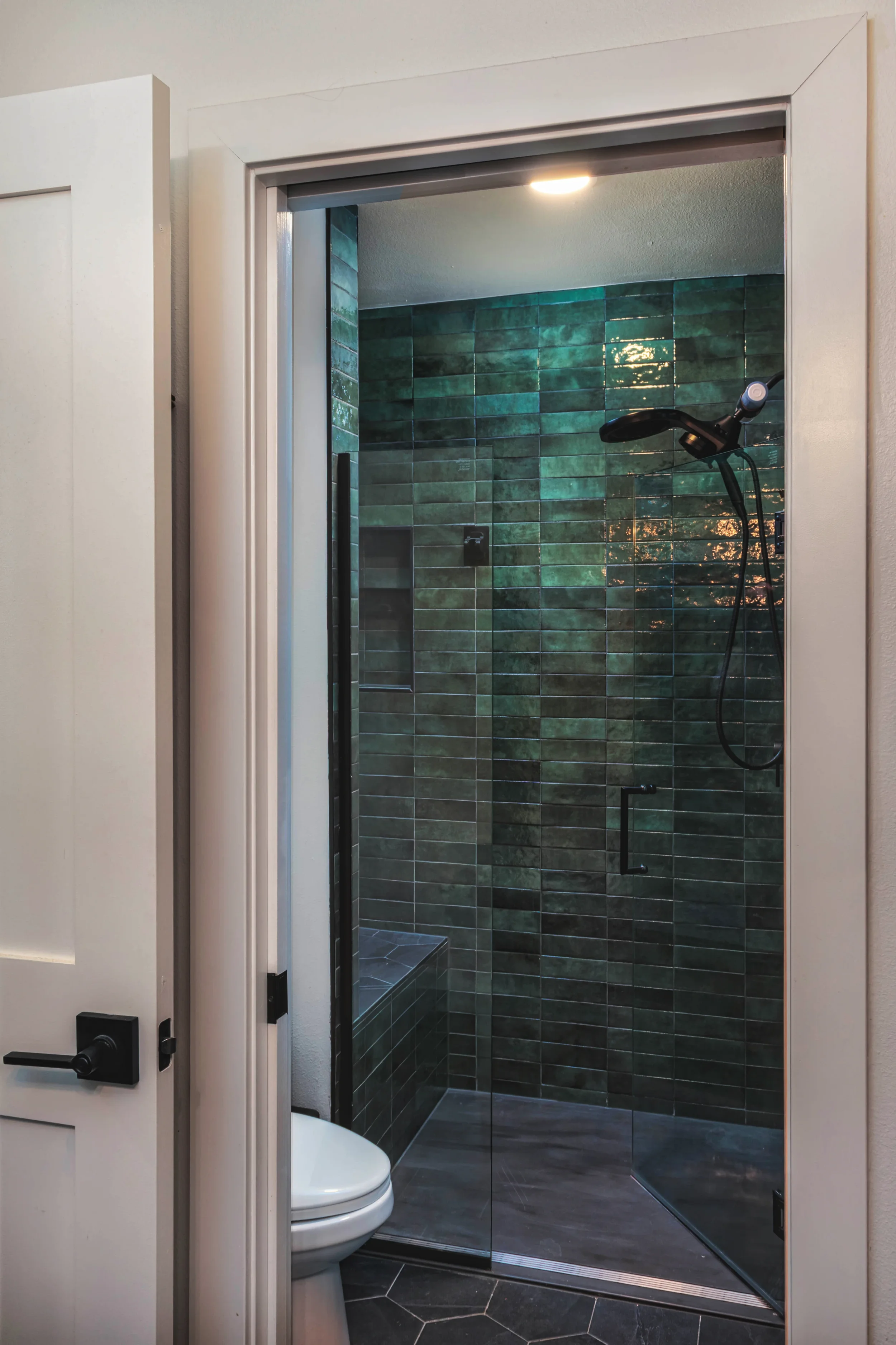 Interior design photography of a custom master shower with high-end tile work and modern fixtures, shot in Colorado by Context Images.