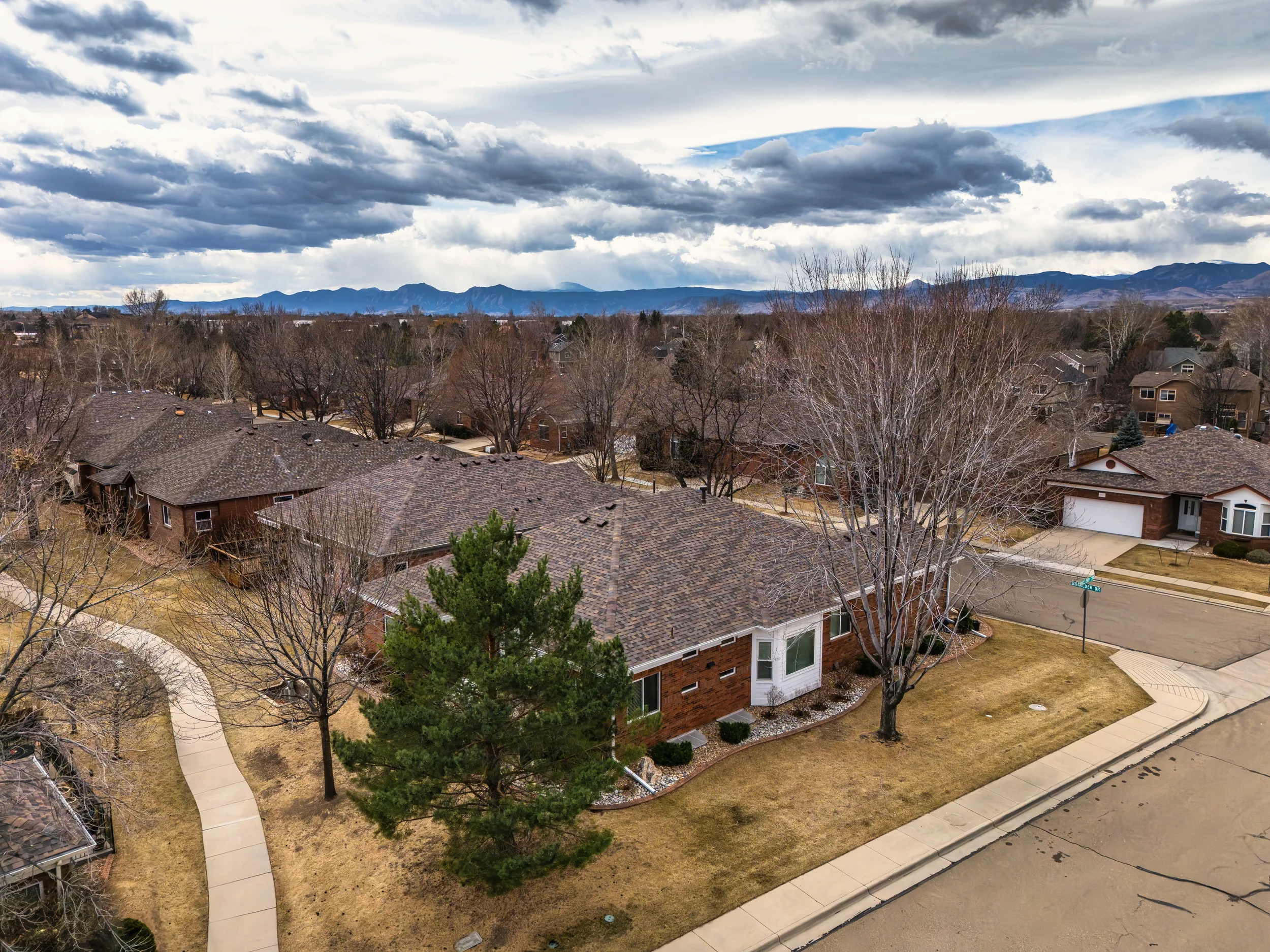 Aerial drone photography of a residential neighborhood in Longmont, Colorado, providing a surrounding context of the property, shot by Context Images.