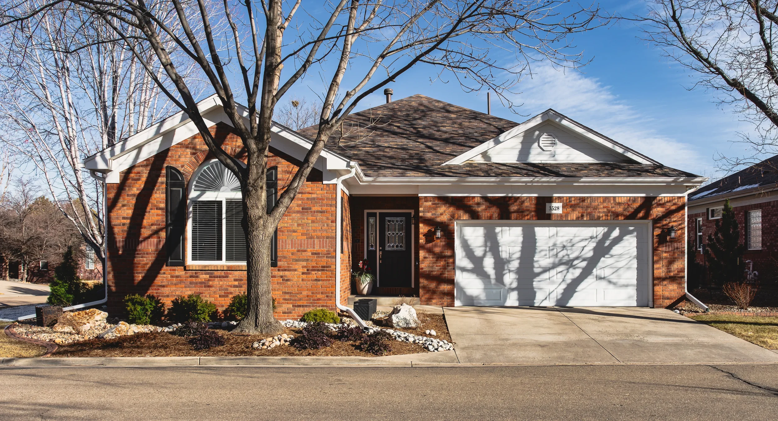 Exterior architectural photography of a modern residential home in Longmont, Colorado, showcasing the front facade and curb appeal, shot by Context Images.