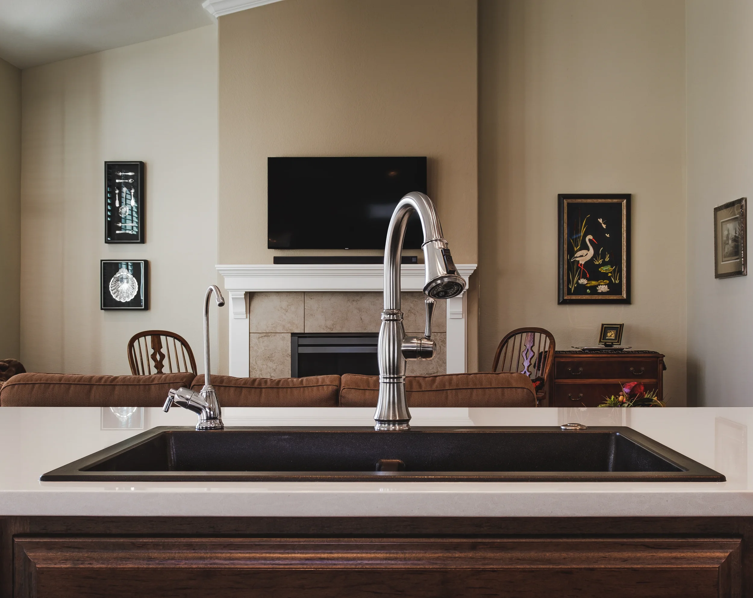 Close-up detail photography of a marble kitchen island with modern fixtures, part of a residential interior design project in Longmont.