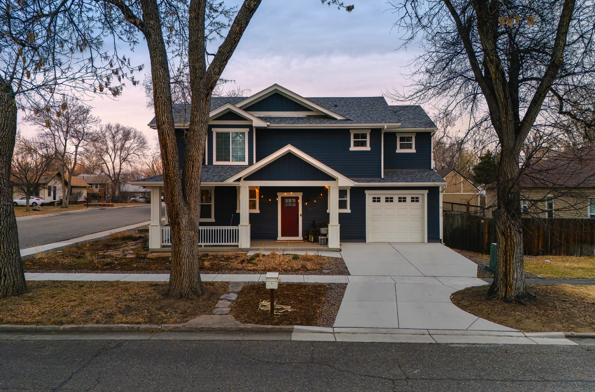 Stunning twilight architectural photography of a luxury home exterior, emphasizing design and curb appeal in Berthoud, Colorado.
