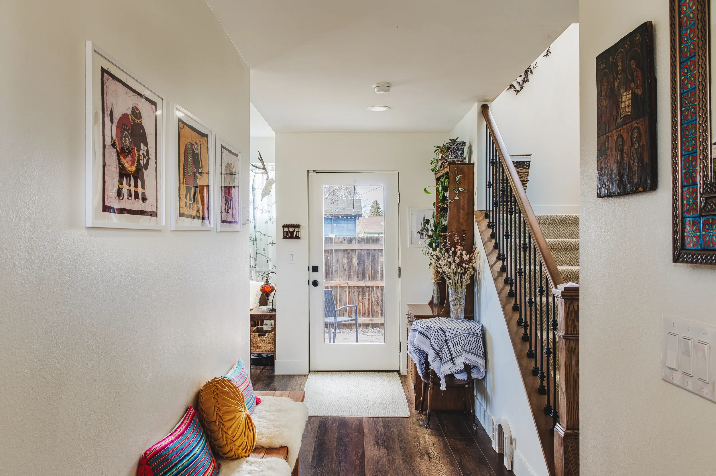 real estate photography of a welcoming home entryway with modern decor and natural wood accents, shot in Berthoud, Colorado by Context Images.