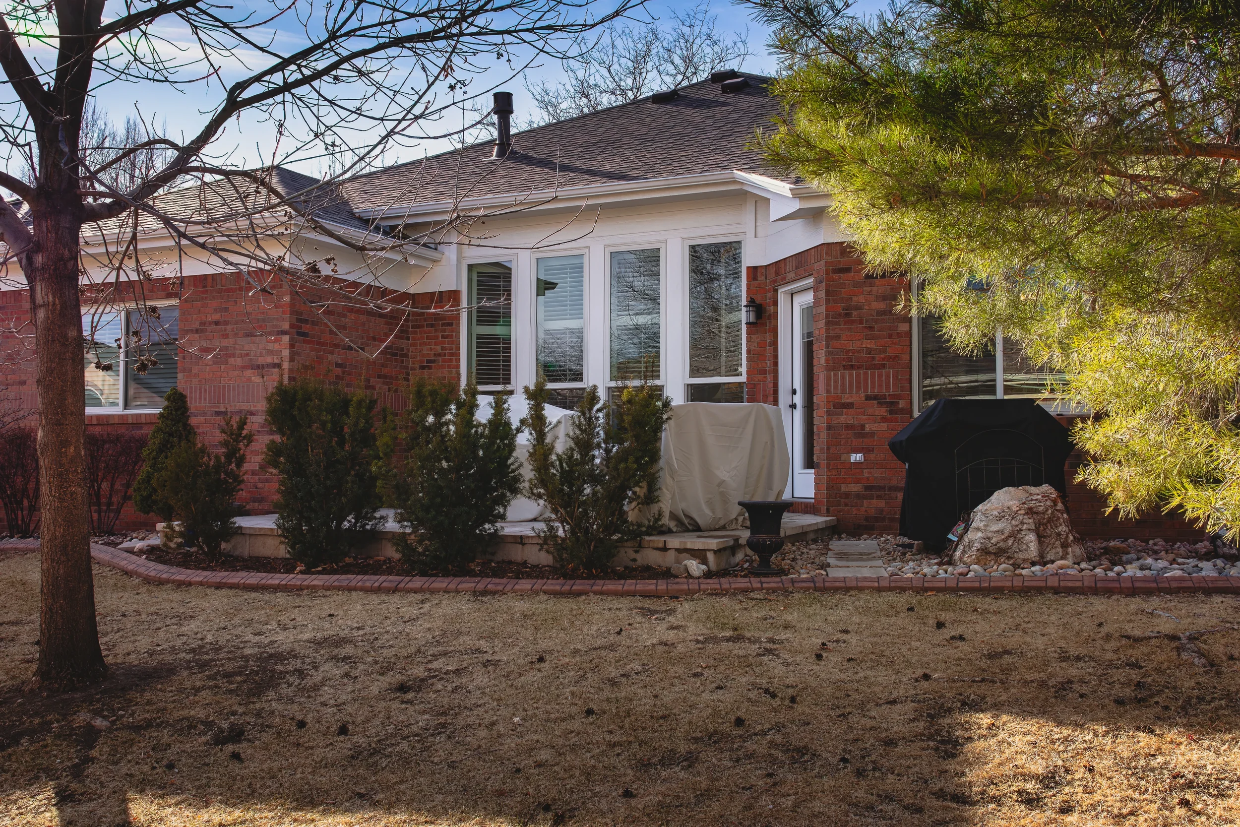 Landscape and exterior photography of a landscaped backyard with outdoor living space, captured in Longmont, Colorado by Context Images.