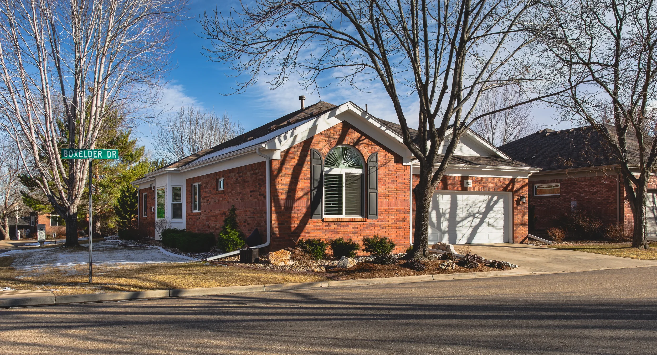 Exterior architectural photography of a modern residential home in Longmont, Colorado, showcasing the side and the front of the home, shot by Context Images.