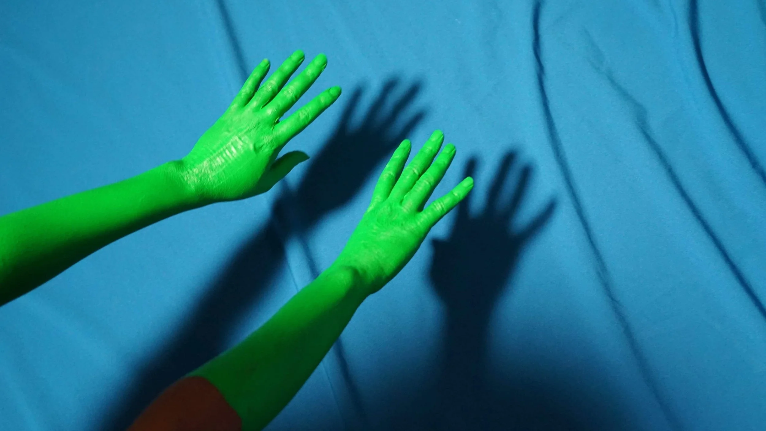 Green Hands on Blue Background