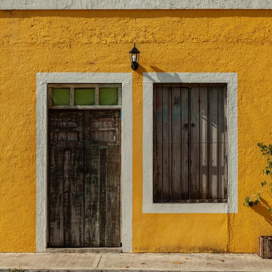 Door and window with bright yellow wall