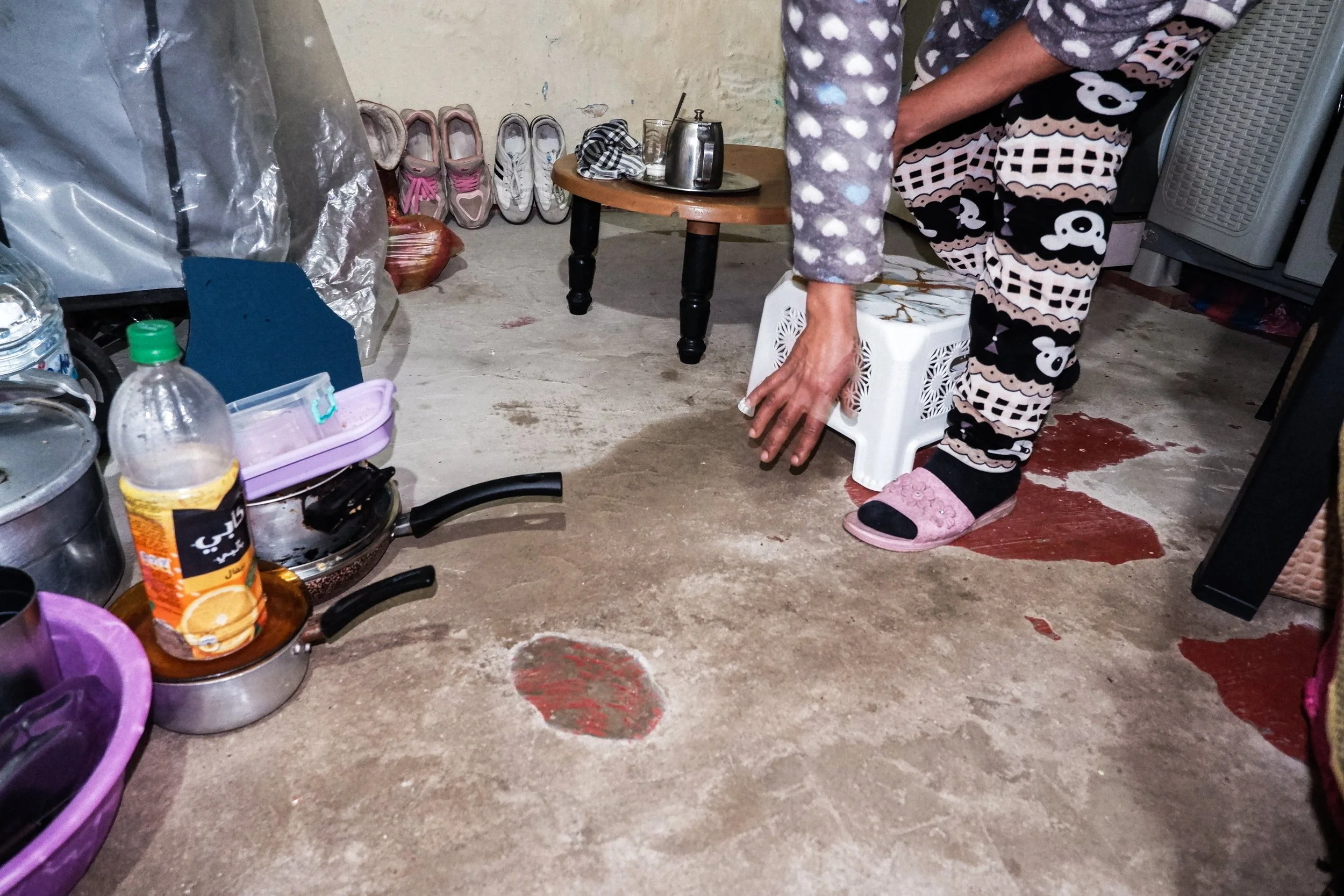 Water traces the same paths through the roof and onto the floor year after year. Arranging kitchenware and stools around the wet concrete, daily routines are built directly around the leaks in a quiet, continuous effort to get by.