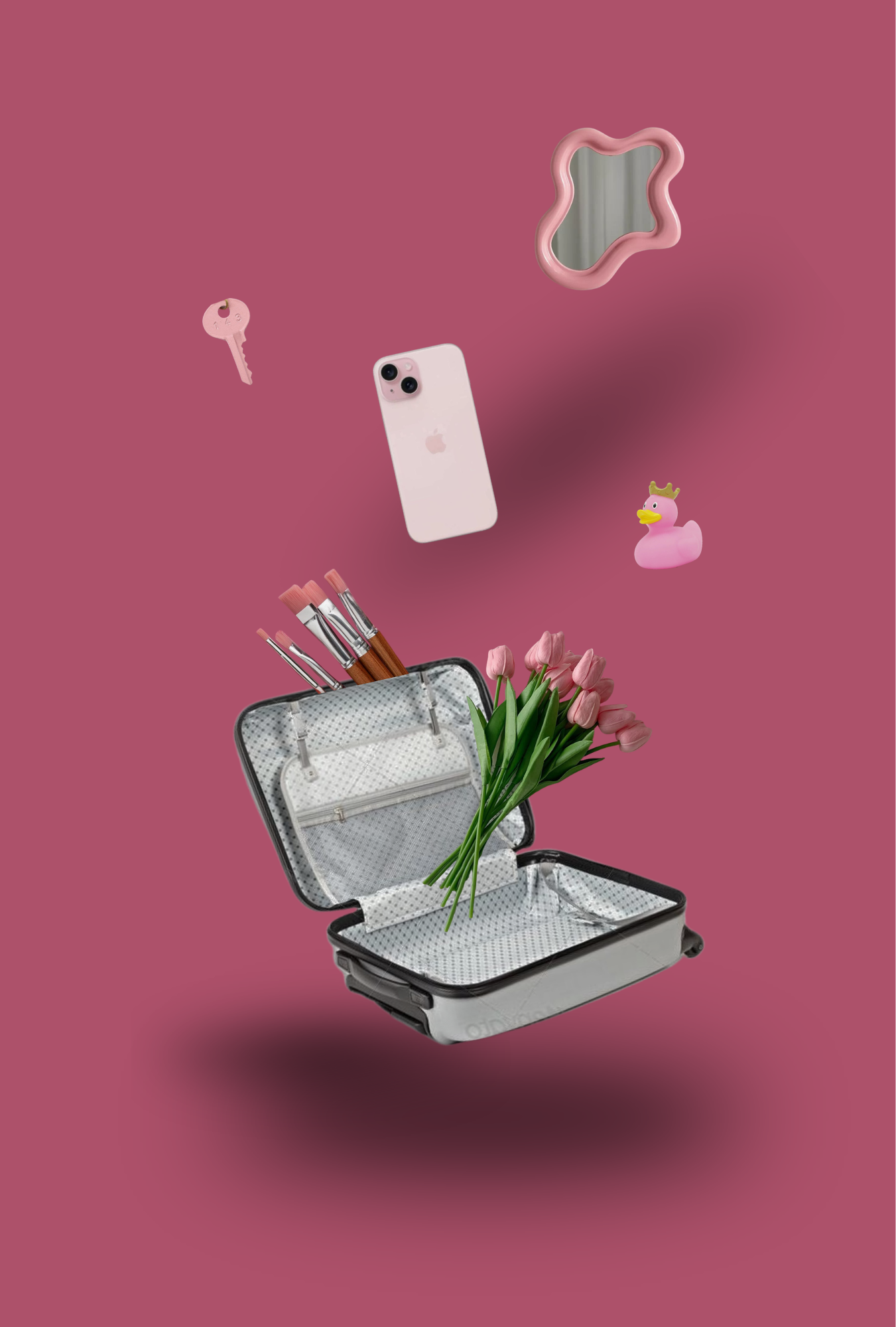 A pink background with a black and white open suitcase floating, containing pink tulips and paintbrushes. Floating objects include a pink key, a pink cloud-shaped mirror, a pink iPhone, and a pink rubber duck with a crown.