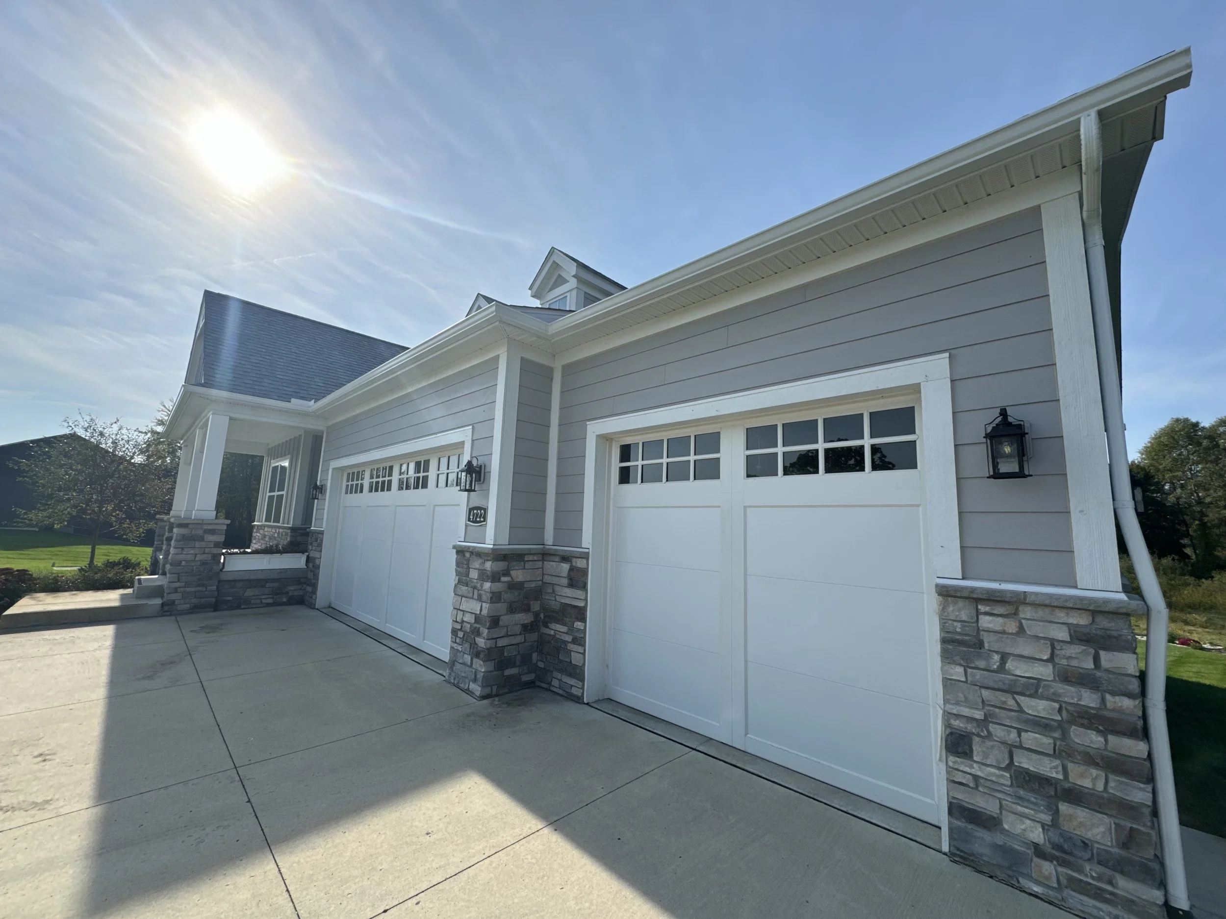 Front view of a modern house built with new seamless white 6' gutters in Brownstown Michigan. seamless gutters with and from dads seamless gutters.