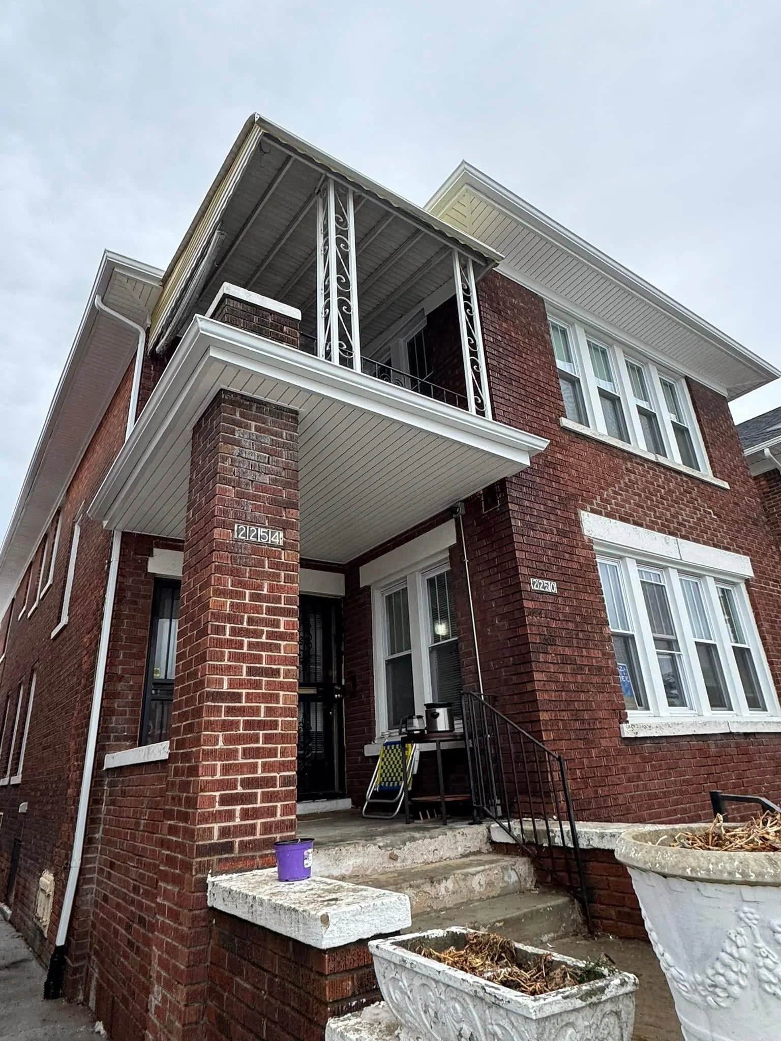 View of a brick apartment building with new seamless gutters by dads seamless gutters in Detroit michigan