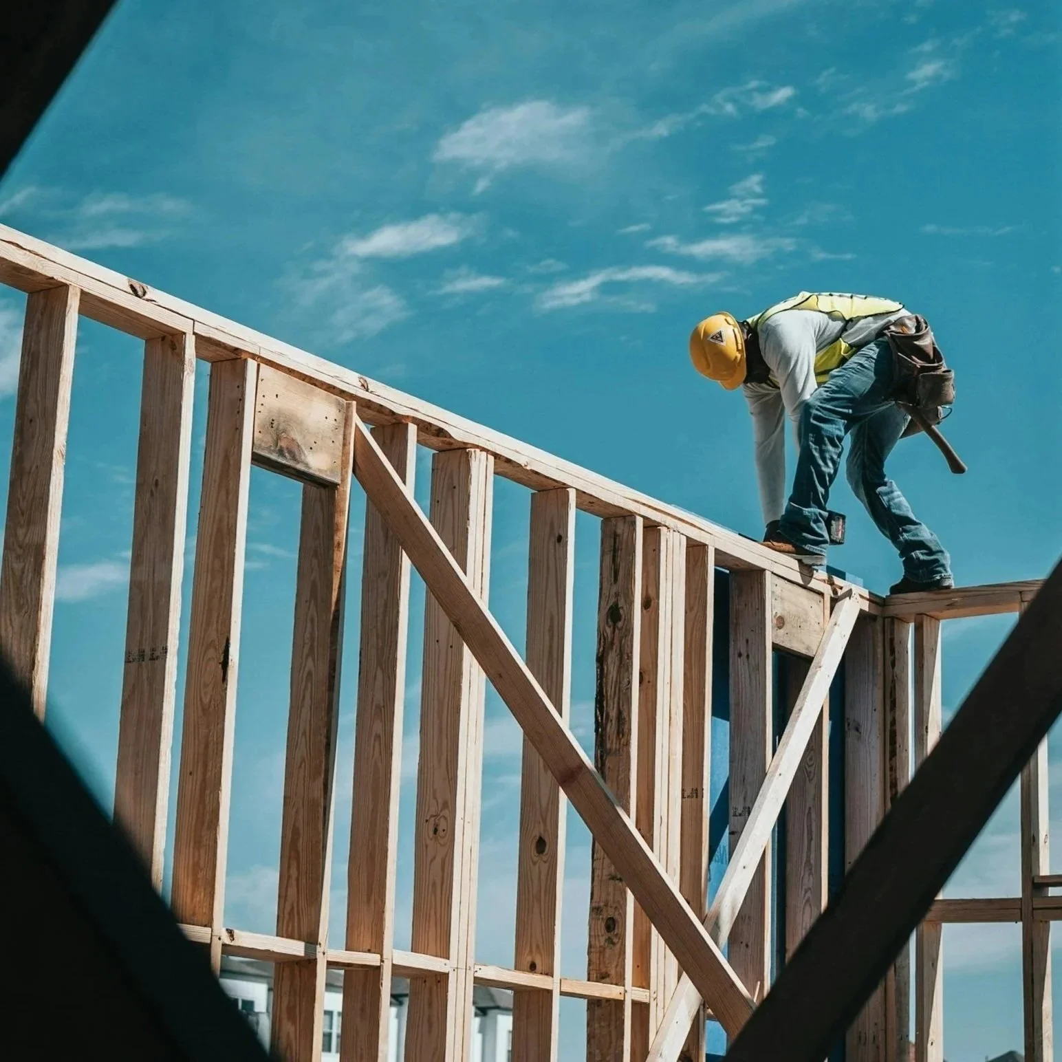 Construction worker building a timber roof structure