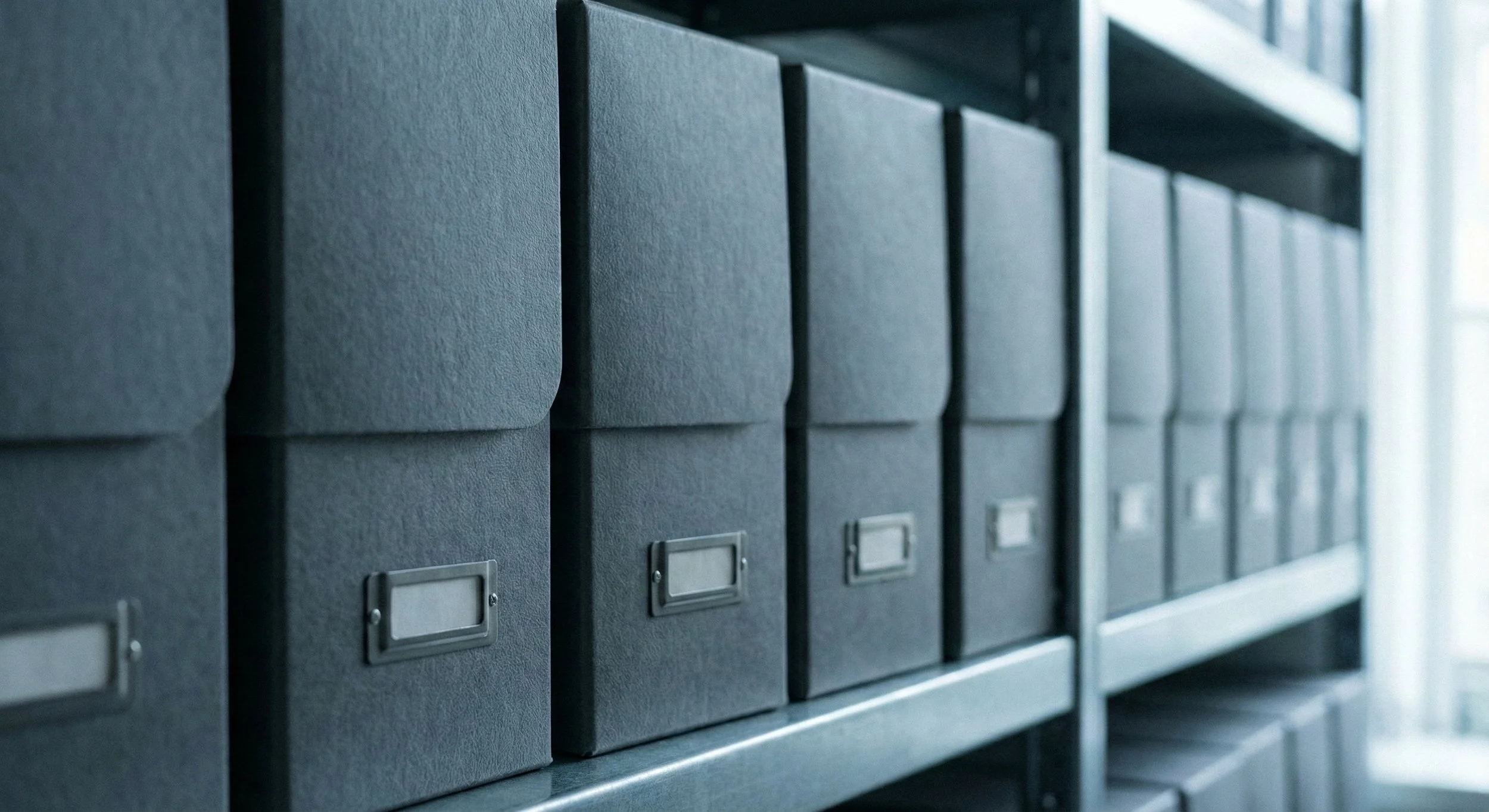 grey boxes stacked on a shelf