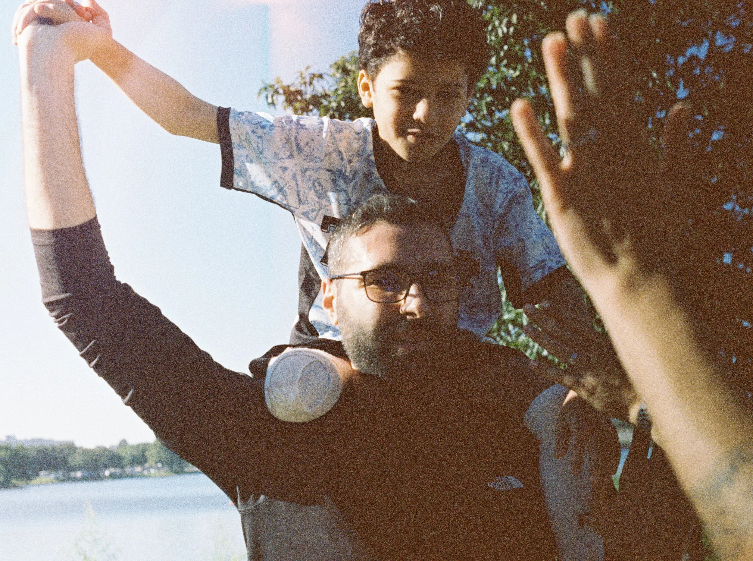 Motaz Azaiza carrying a young boy on his shoulders at the Gaza 5k in Dallas, 2024.