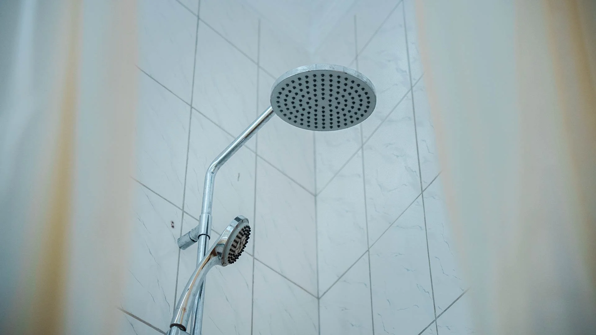 Showerhead mounted on tiled bathroom wall at Quality Inn Hotel Kigali, Rwanda