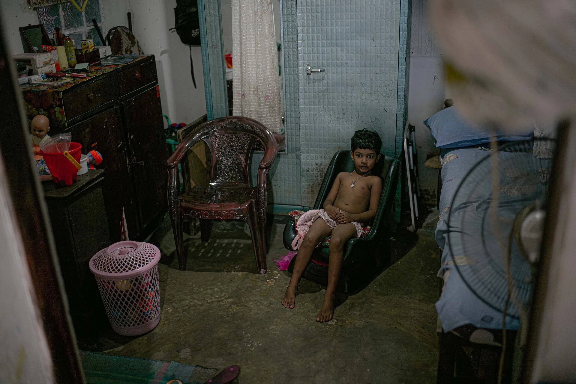 Boy sitting in a chair in a home in Colombo, Sri Lanka.