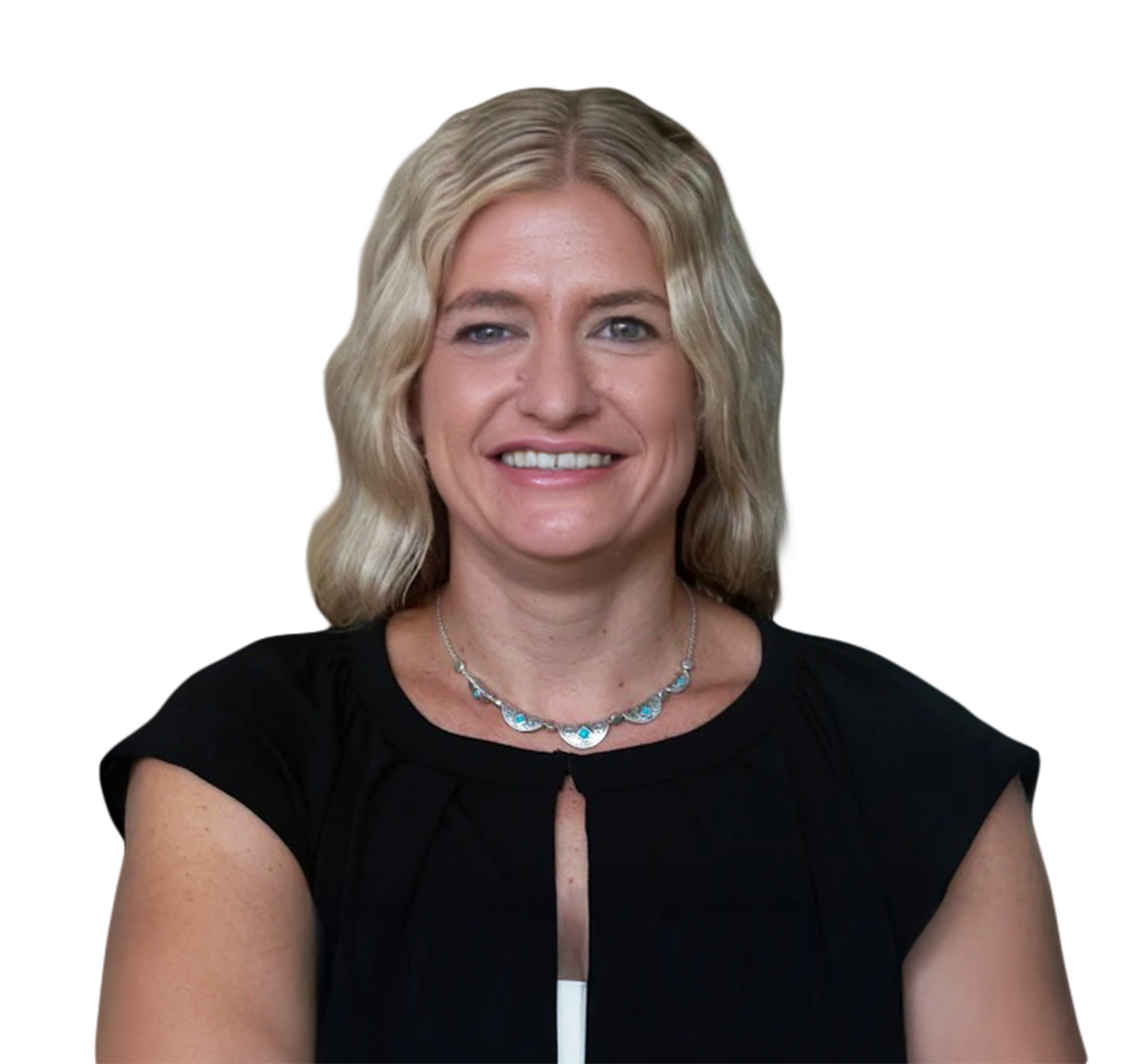 A woman with blond hair wearing a black top and a silver necklace, smiling at the camera.