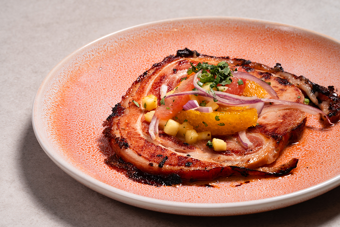 Grilled pork belly topped with valencia mandarin oranges, grapefruit, pineapple, red onion, cilantro, green onion, bitter orange chiltepin-piloncillo vinaigrette.