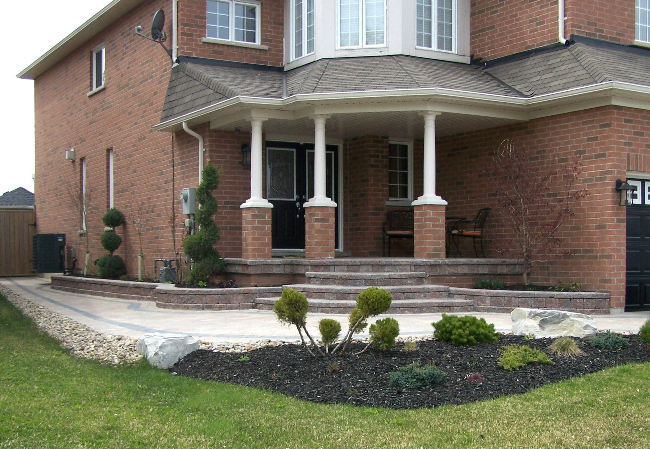 Custom Interlock Steps, Patio, and Walkway with Custom Flower Boxes, Bordered with River Rock for Proper Drainage
 - Newmarket