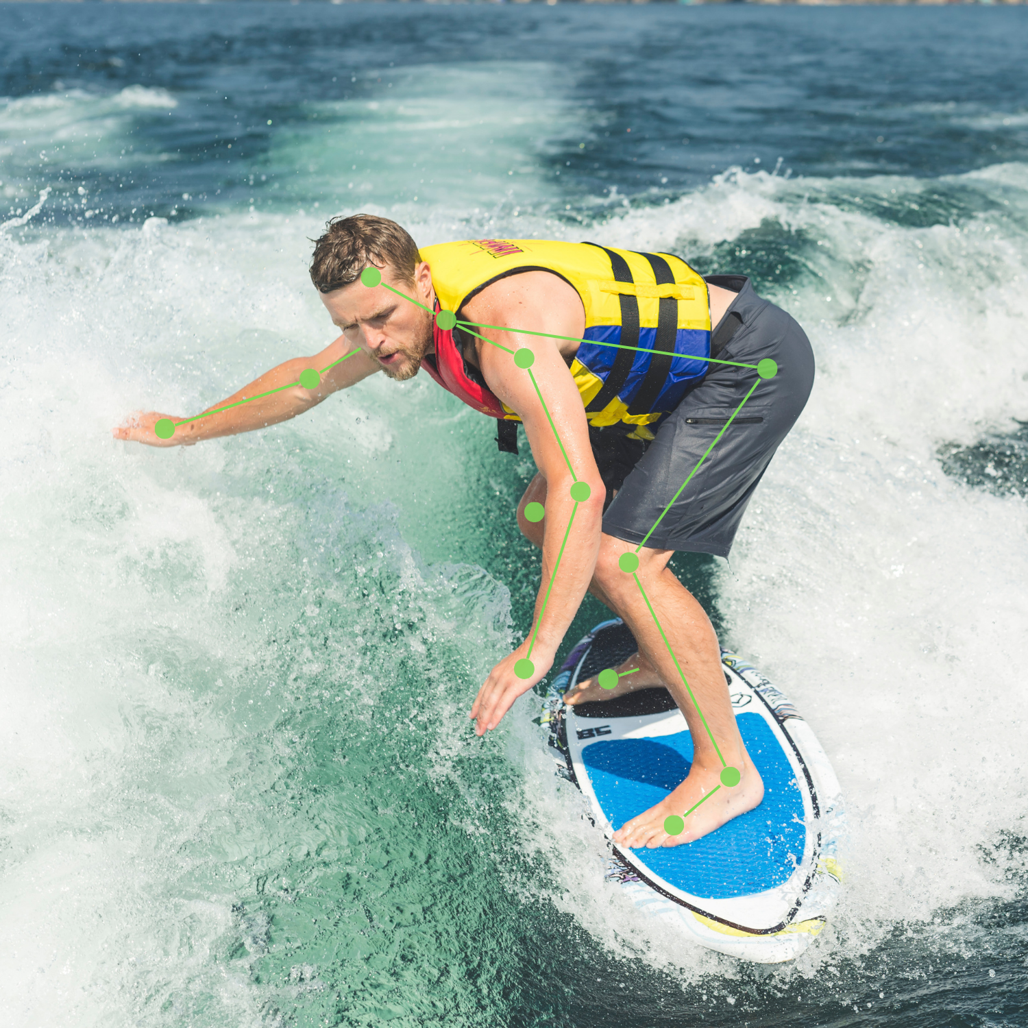 A man wearing a yellow life jacket and black shorts surfing on a blue surfboard in the ocean.