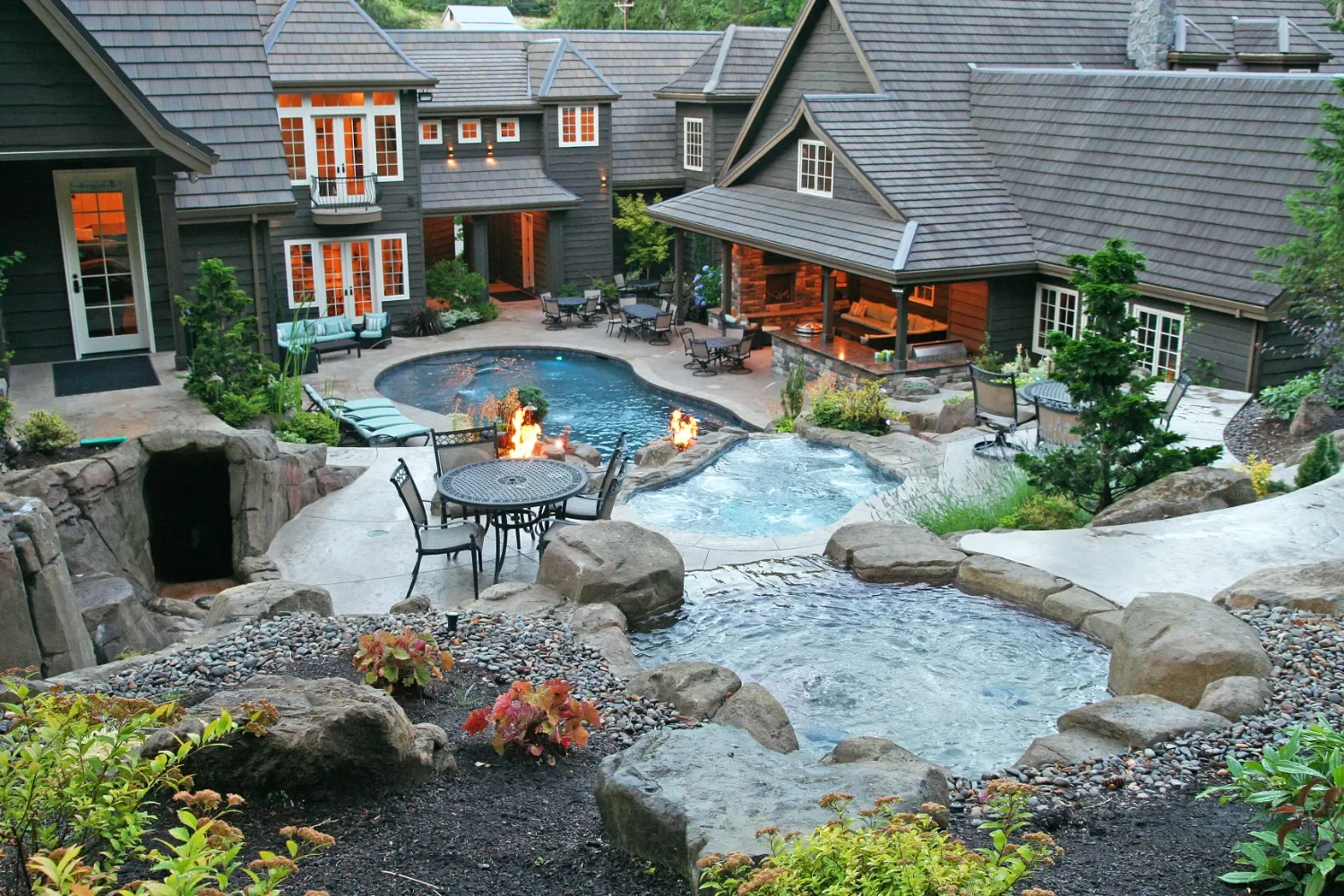 Gorgeous rich backyard with pool, spa, outdoor kitchen, fire features, and plantings