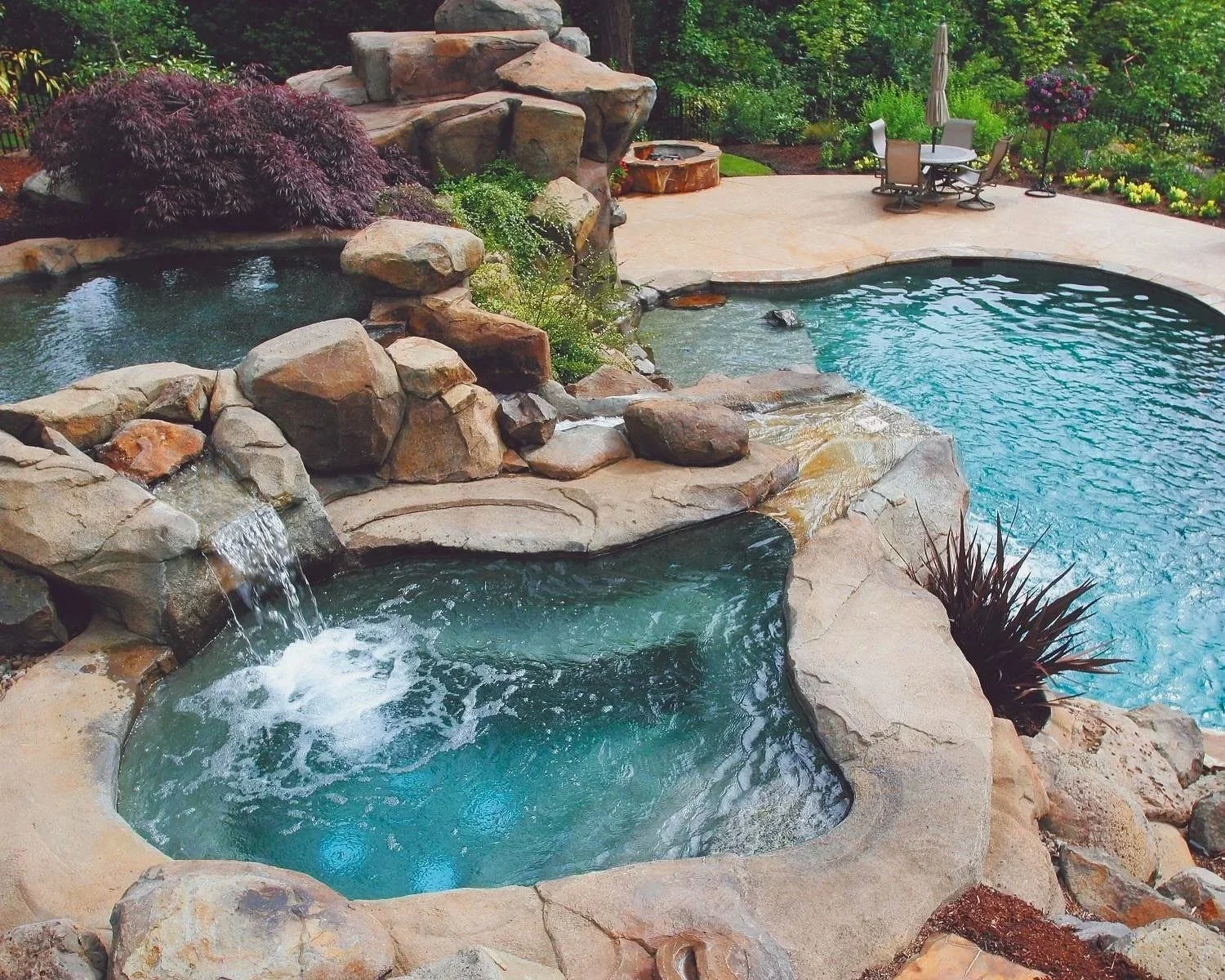 Residential luxury pool with natural stone and cascading waterfalls