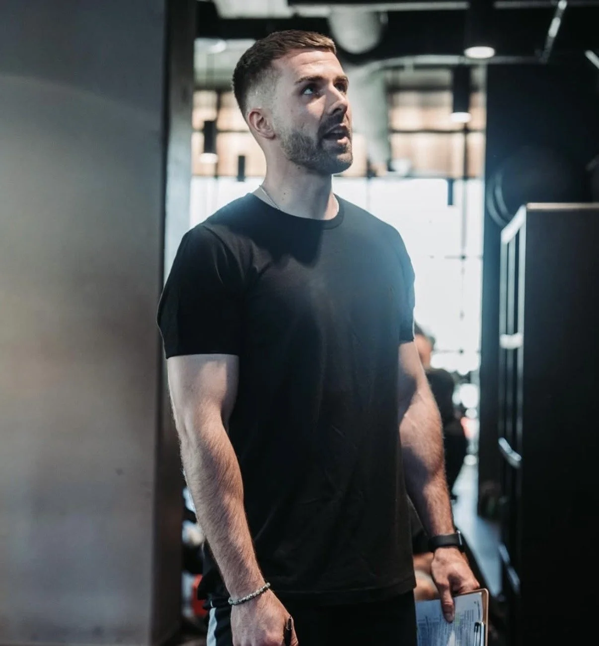 Personal trainer Jordan Walshaw coaching a client in the gym