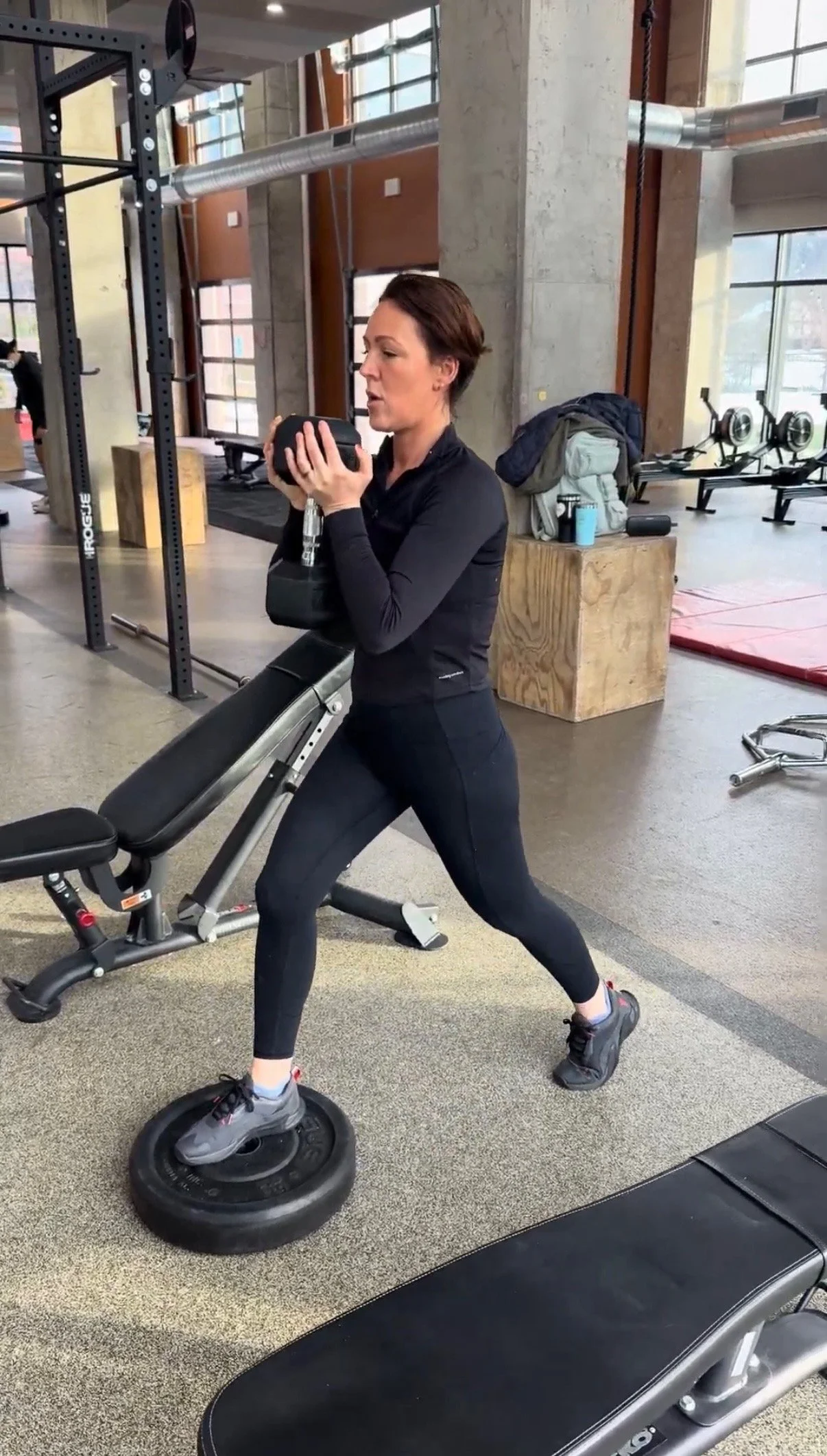 Lana, personal training client, performing a weighted lunge
