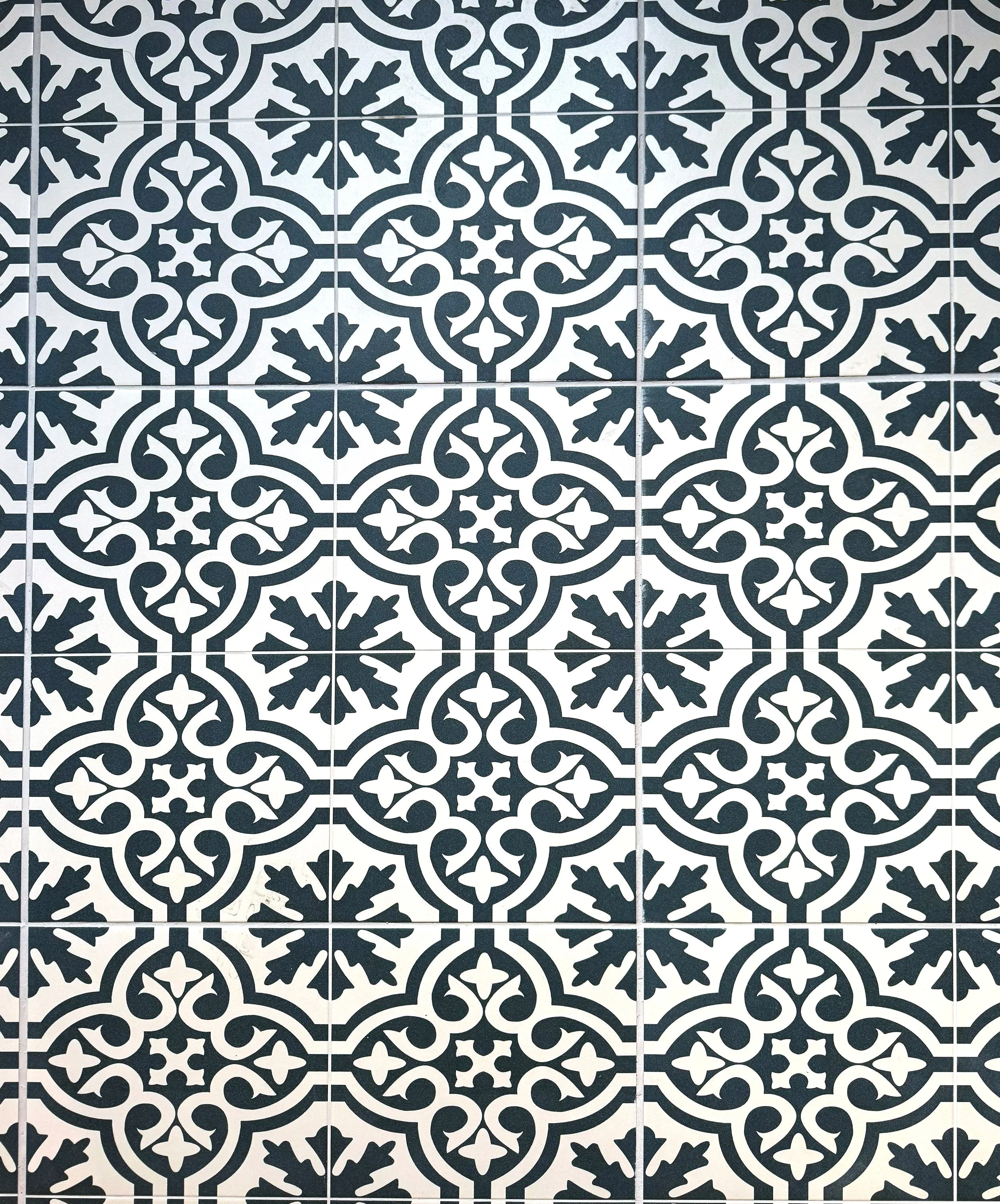 Patterned black and white decorative tiles with intricate geometric designs.