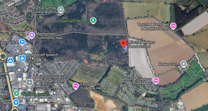 Satellite map showing areas in Ipswich with labels for schools, parks, community hall, farms, and residential areas.